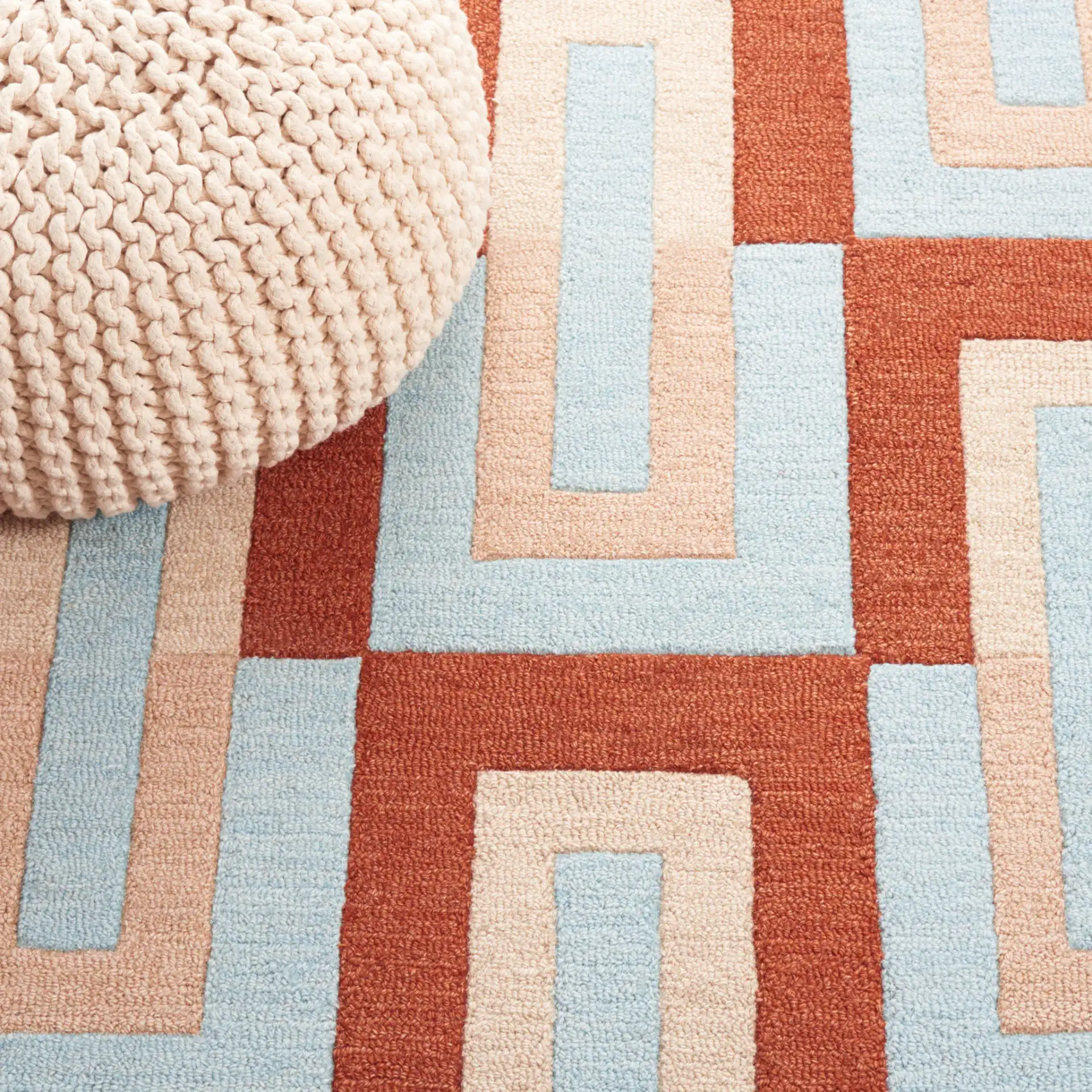 Genre Interlocking Rectangles Hand-Tufted Wool Rug in Light Blue / Rust in a styled room