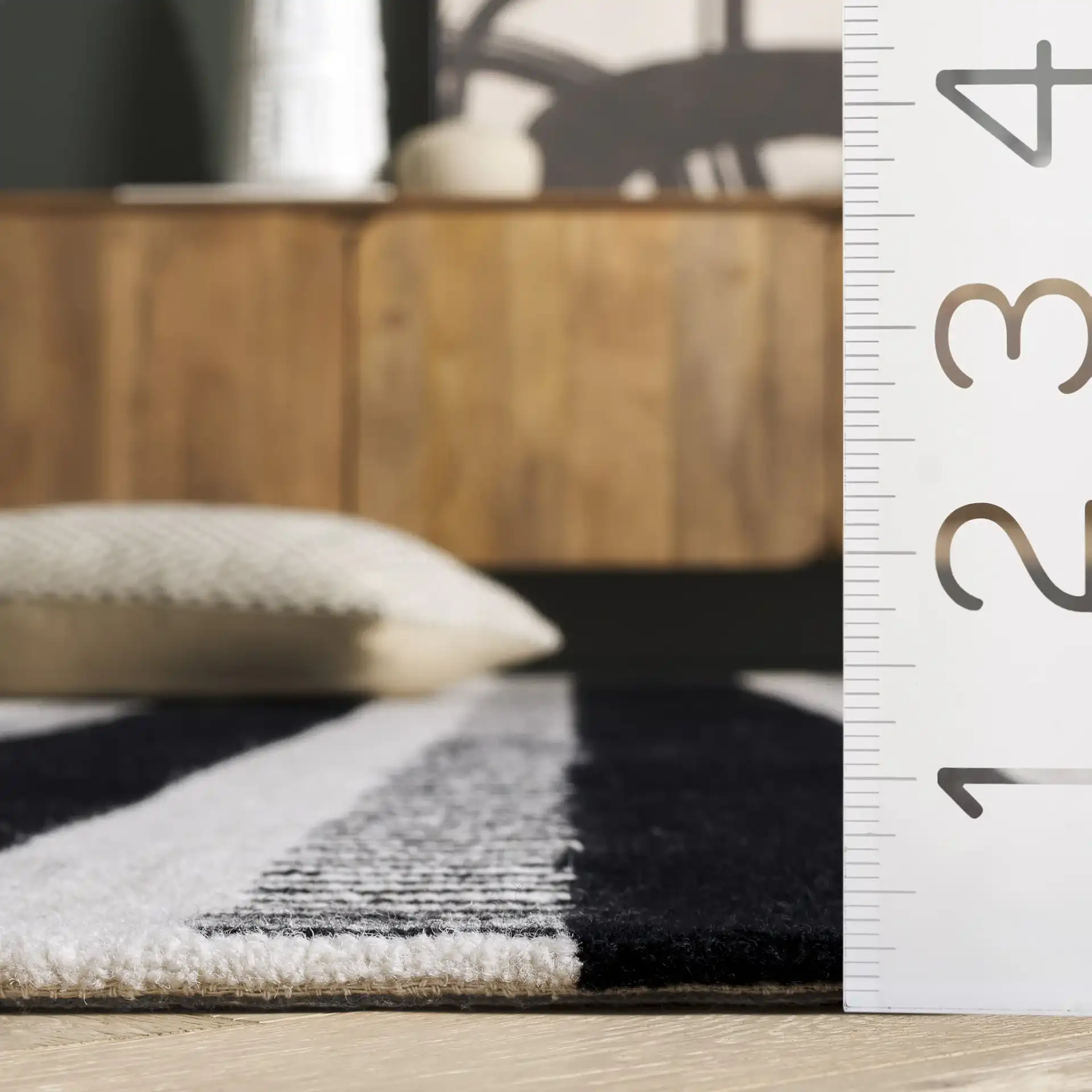 Genre Ladder Stripe Hand-Tufted Wool Rug in Black / Ivory in a styled room