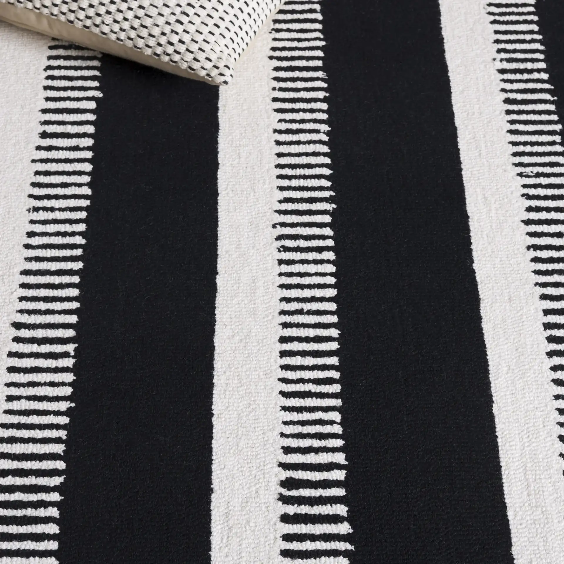 Genre Ladder Stripe Hand-Tufted Wool Rug in Black / Ivory in a styled room