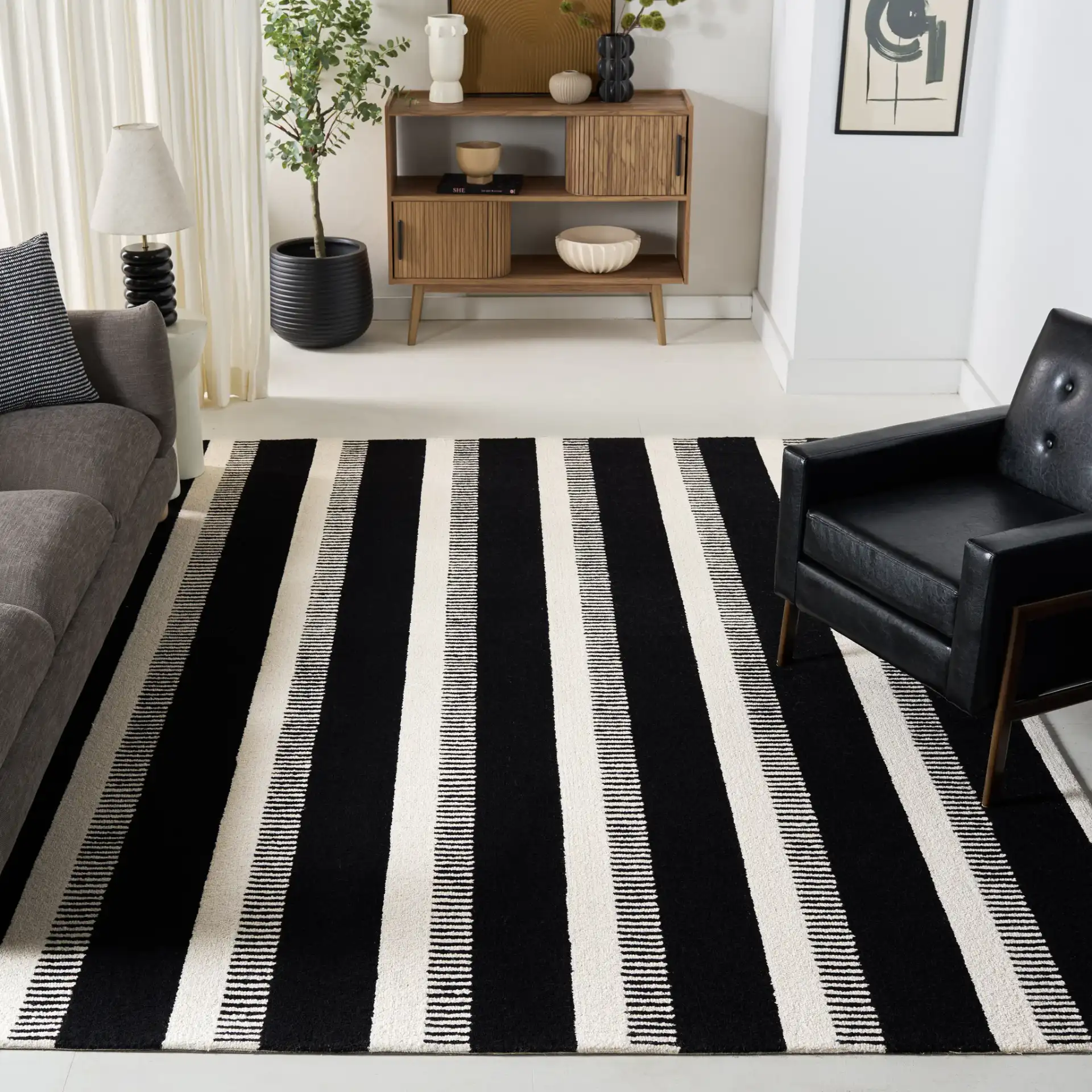 Genre Ladder Stripe Hand-Tufted Wool Rug in Black / Ivory in a styled room