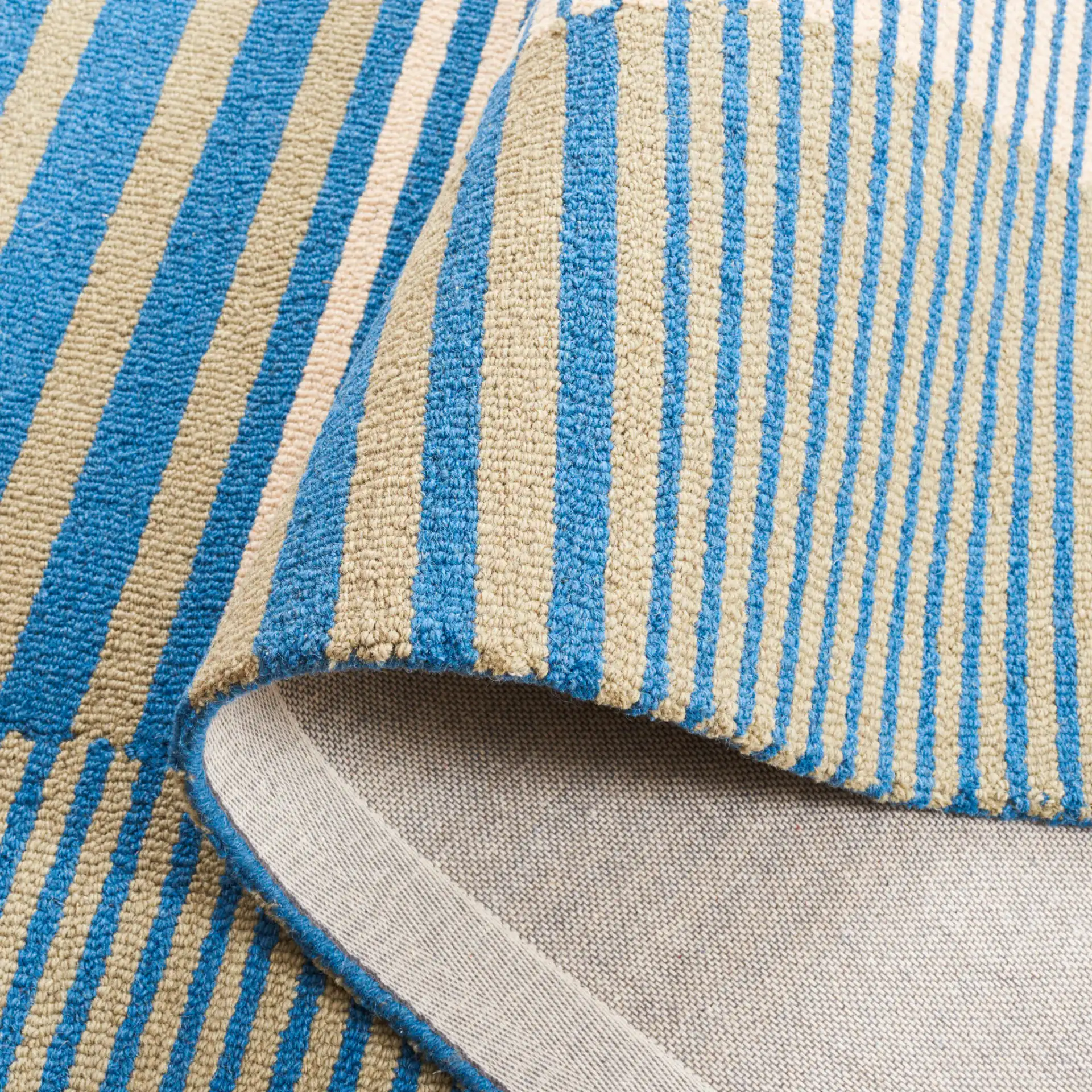 Genre Blocked Stripe Hand-Tufted Wool Rug in Blue / Ivory in a styled room
