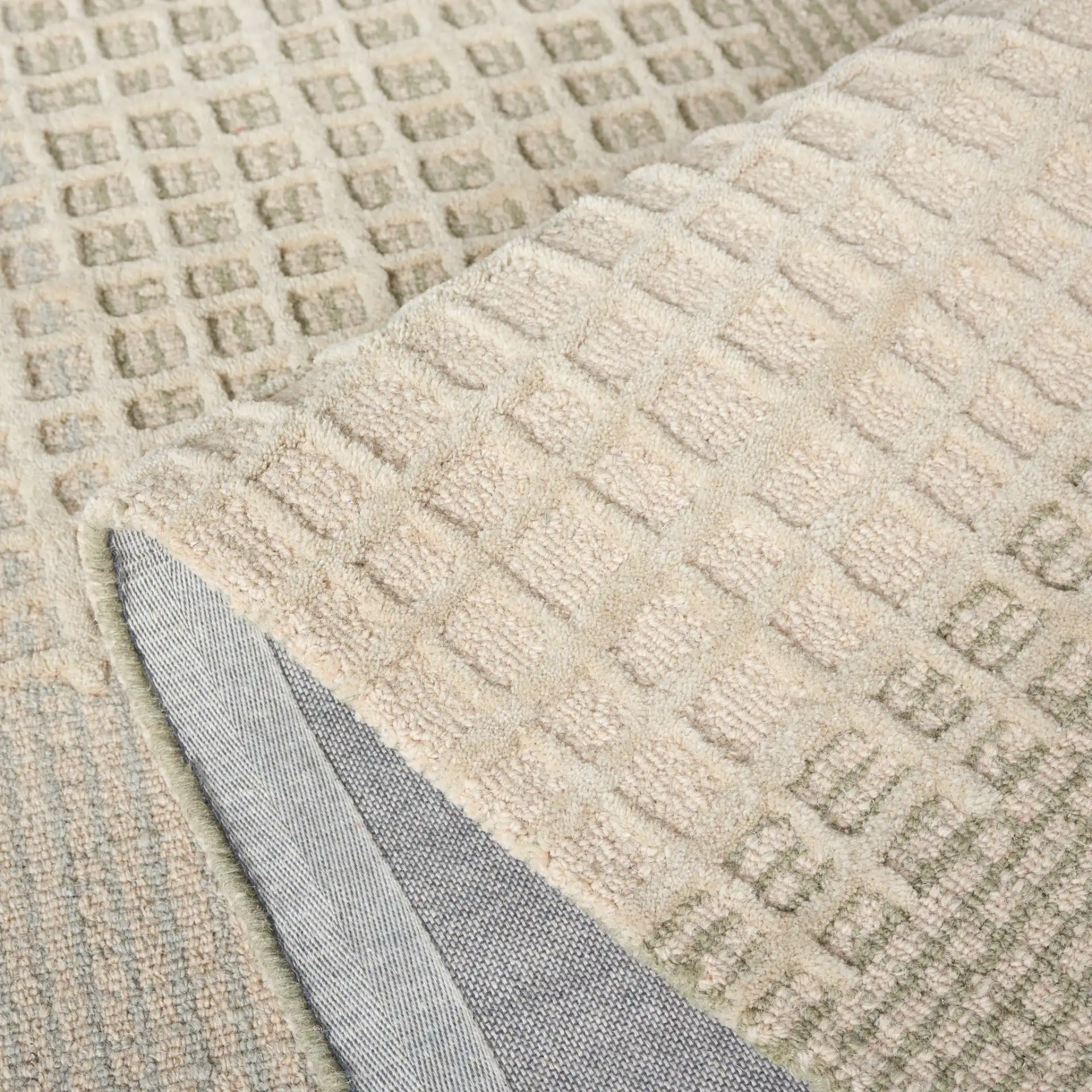 Genre Textured Grid Hand-Tufted Wool Rug in Beige / Gray in a styled room