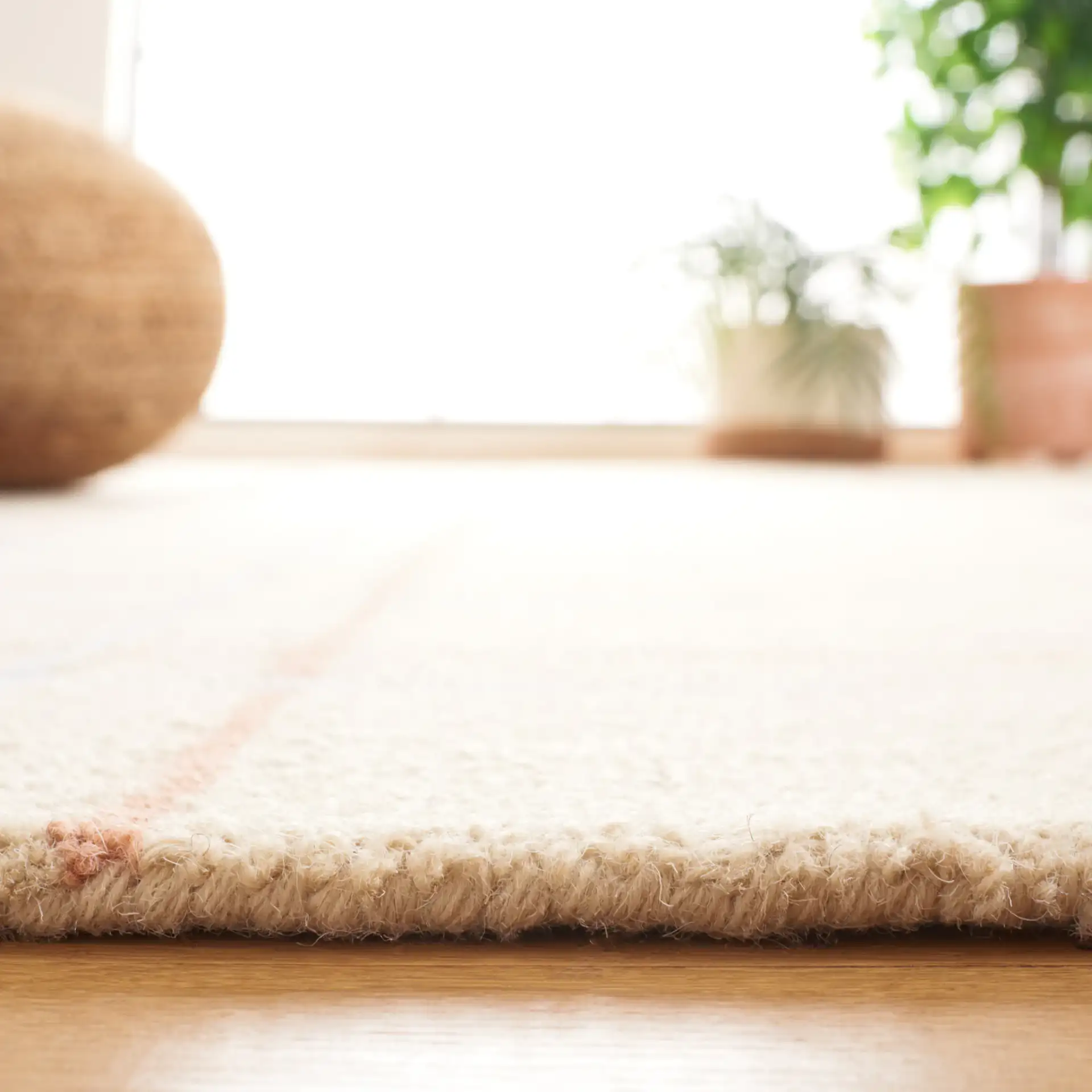 Genre Asymmetric Grid Hand-Tufted Wool Rug in Beige / Rust in a styled room