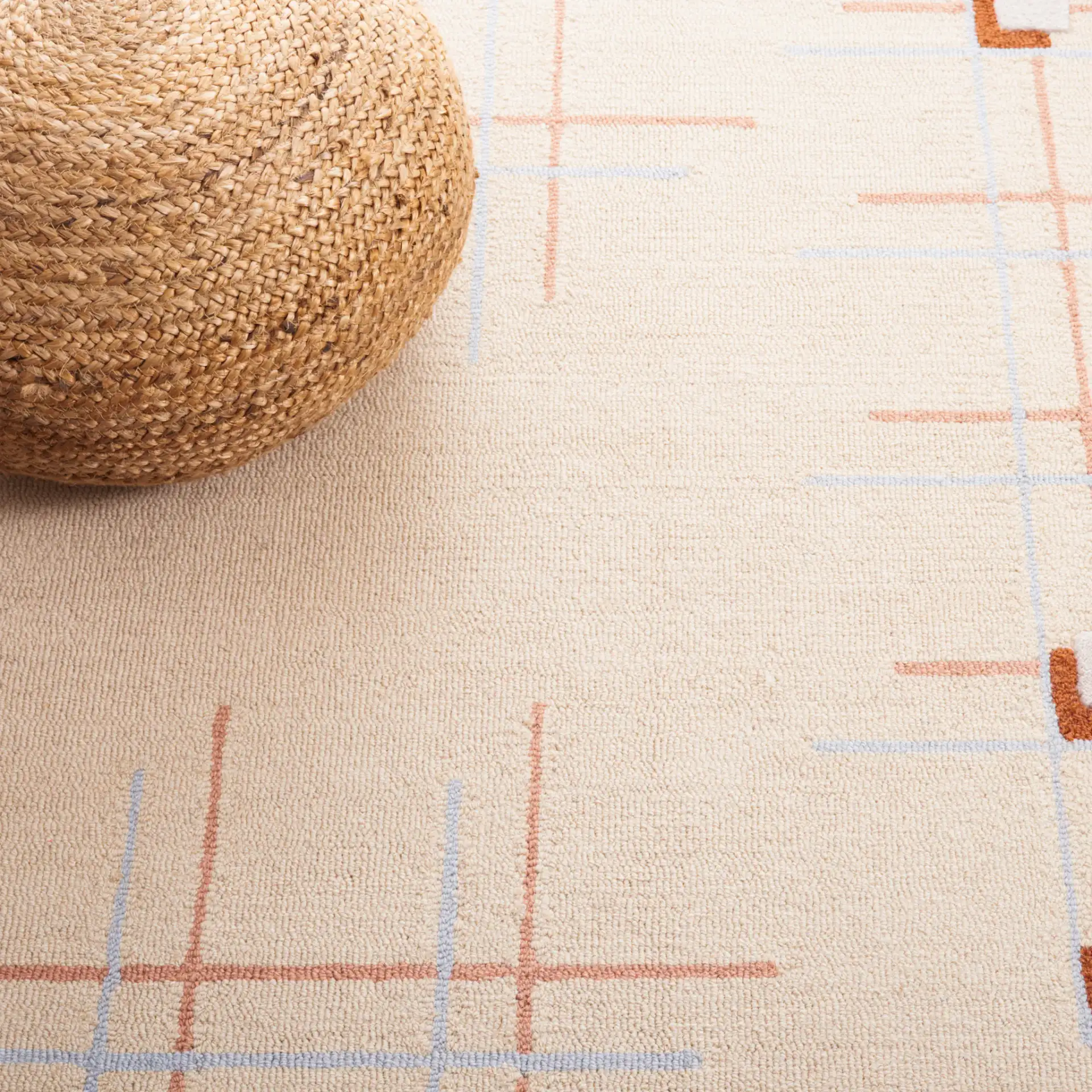 Genre Asymmetric Grid Hand-Tufted Wool Rug in Beige / Rust in a styled room