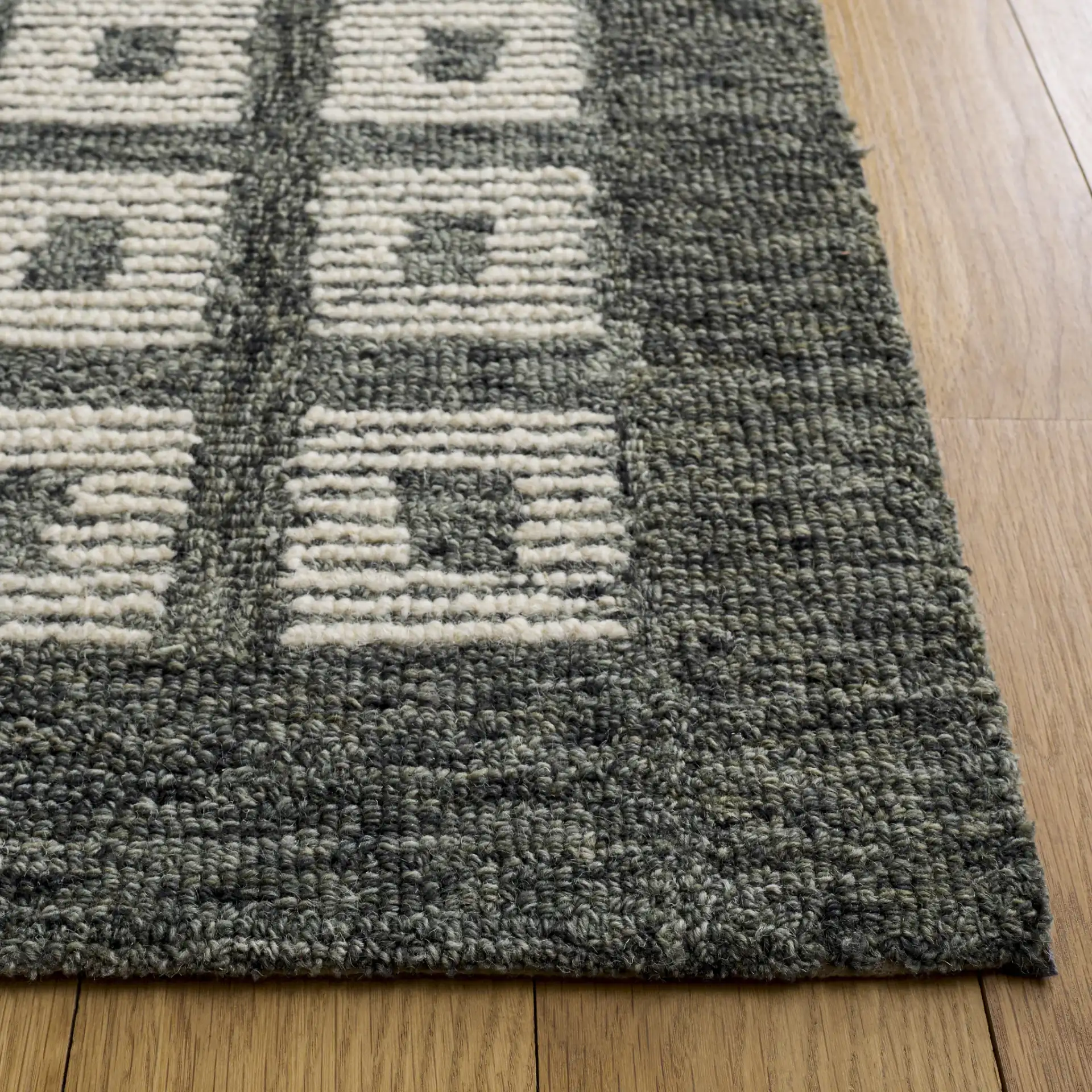 Genre Modern Grid Hand-Tufted Wool Rug in Green / Ivory in a styled room