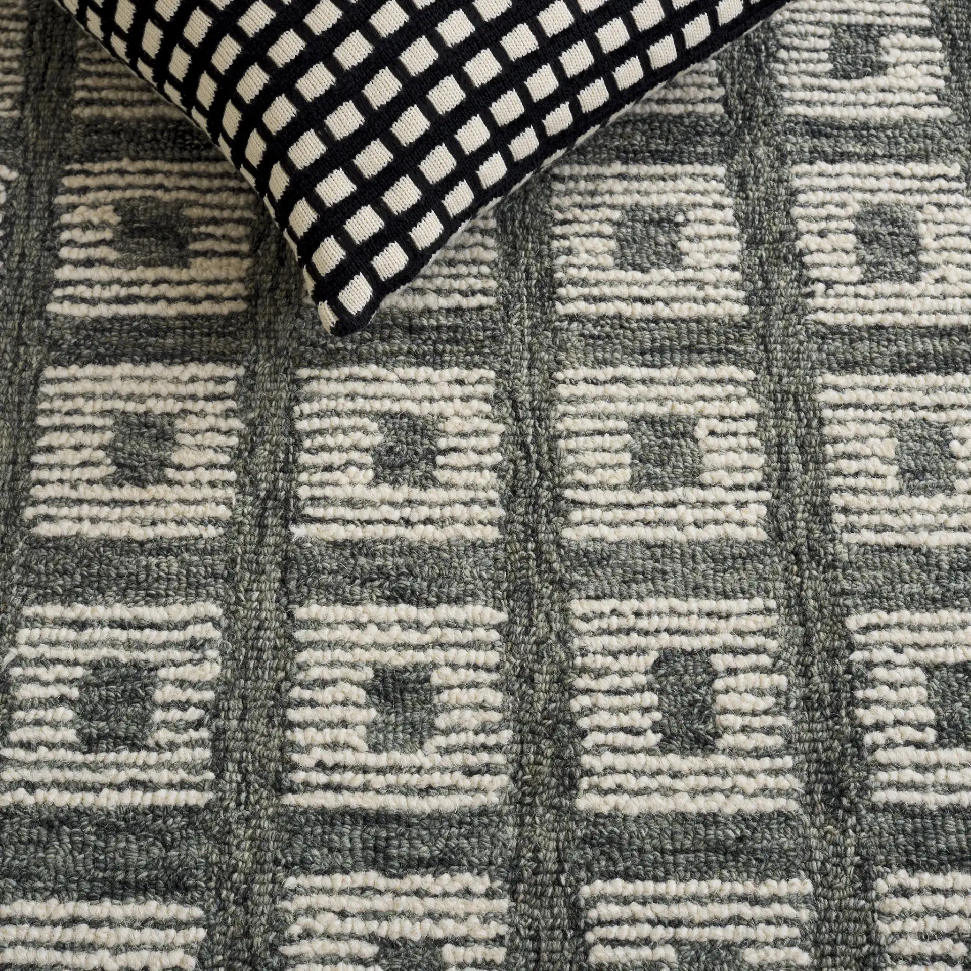Genre Modern Grid Hand-Tufted Wool Rug in Green / Ivory in a styled room