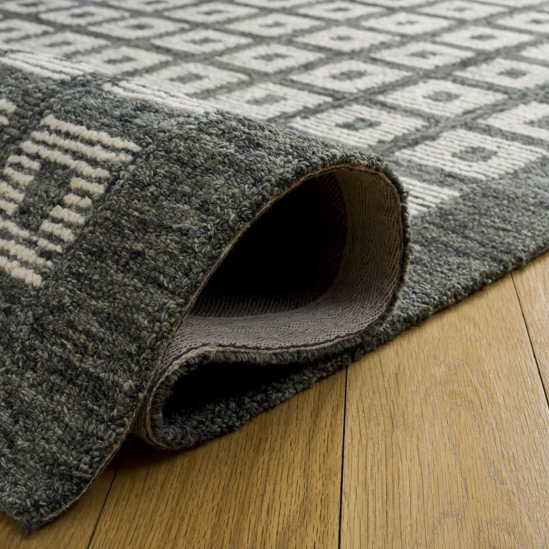 Genre Modern Grid Hand-Tufted Wool Rug in Green / Ivory in a styled room