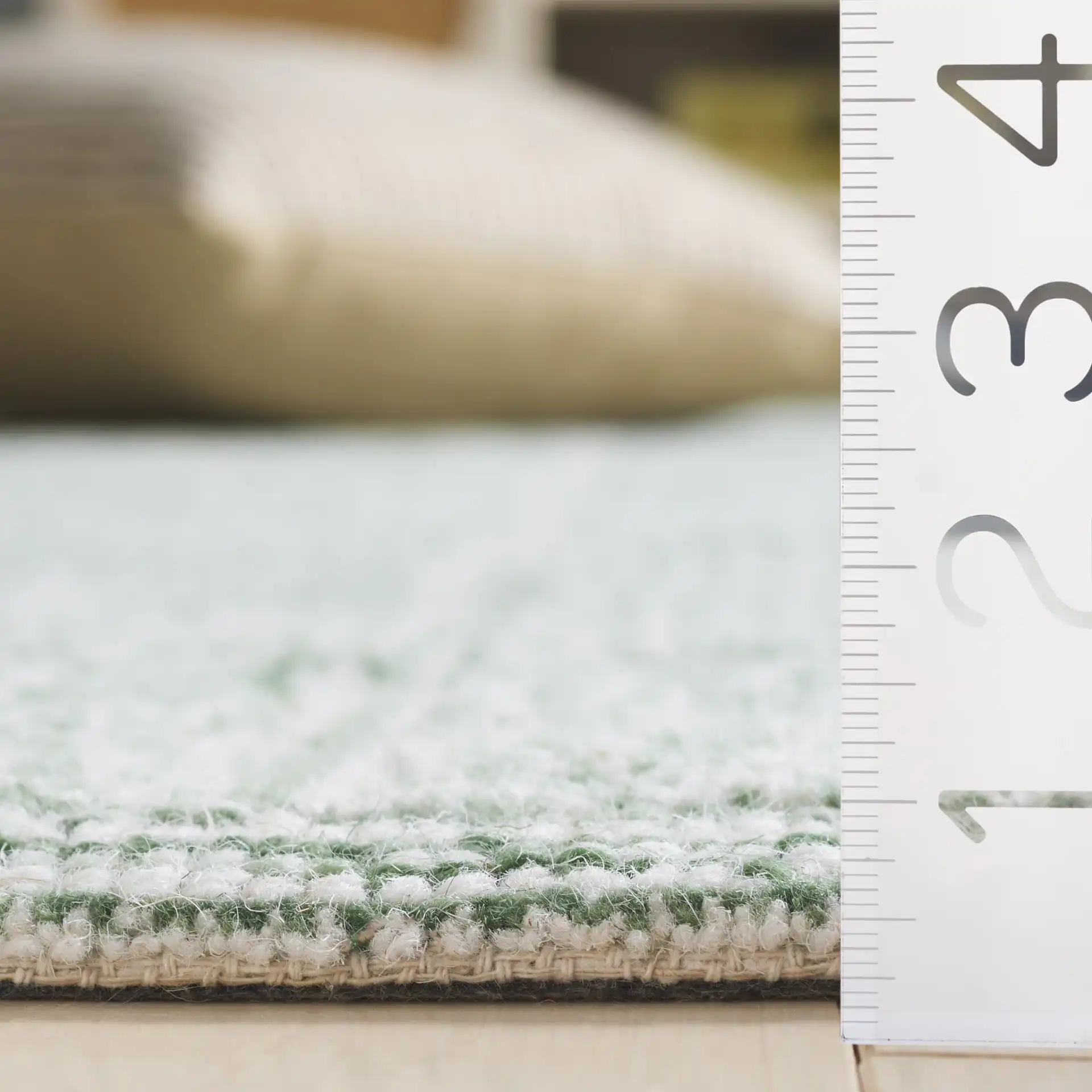 Genre Grid Hand-Woven Wool Rug in Green / Ivory in a styled room