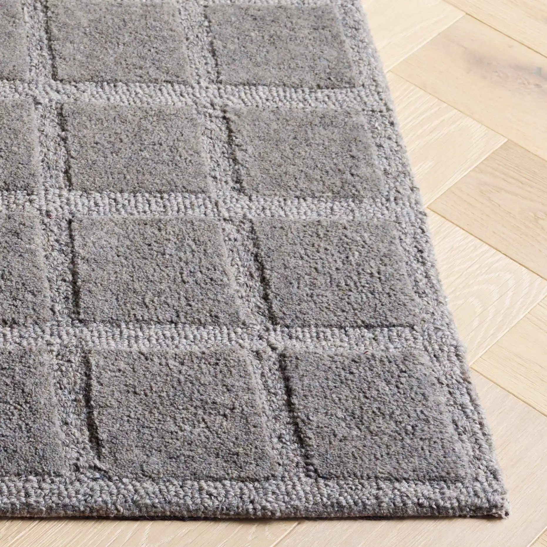 Genre Carved Grid Hand-Tufted Wool Rug in Gray in a styled room