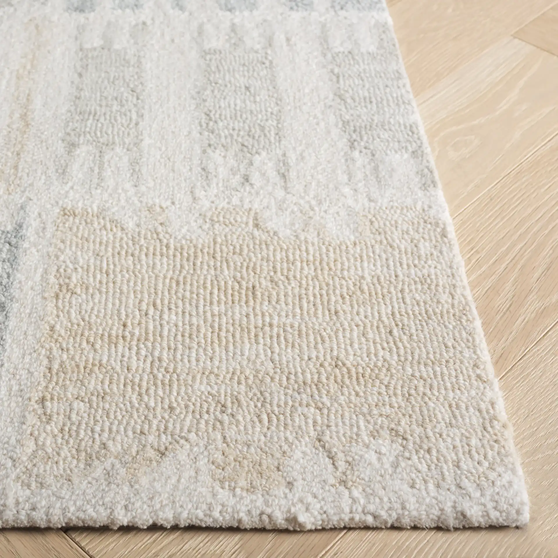 Genre Checkered Block Hand-Tufted Wool Rug in Beige / Gray in a styled room