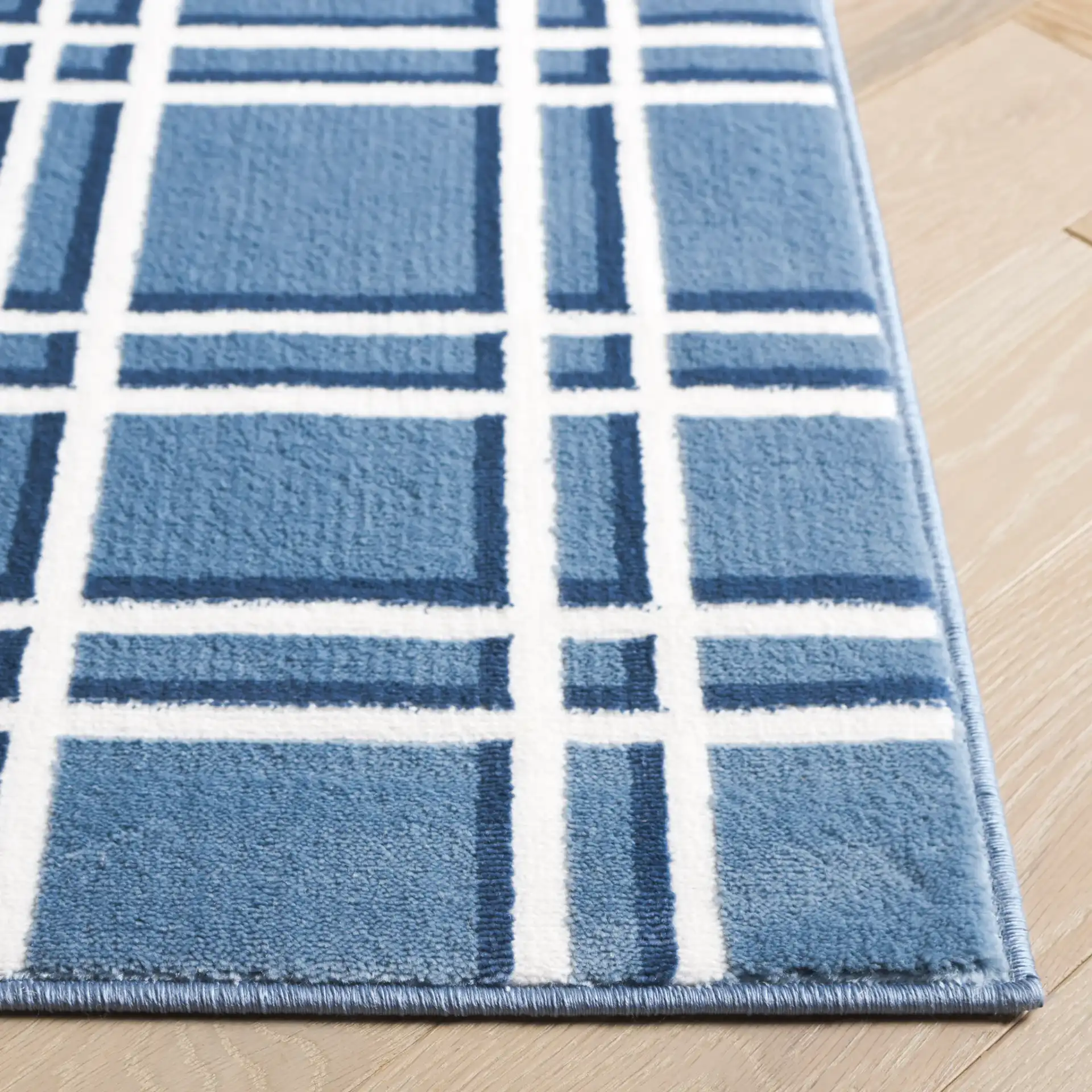 Groove Grid Rug in Blue / Ivory in a styled room