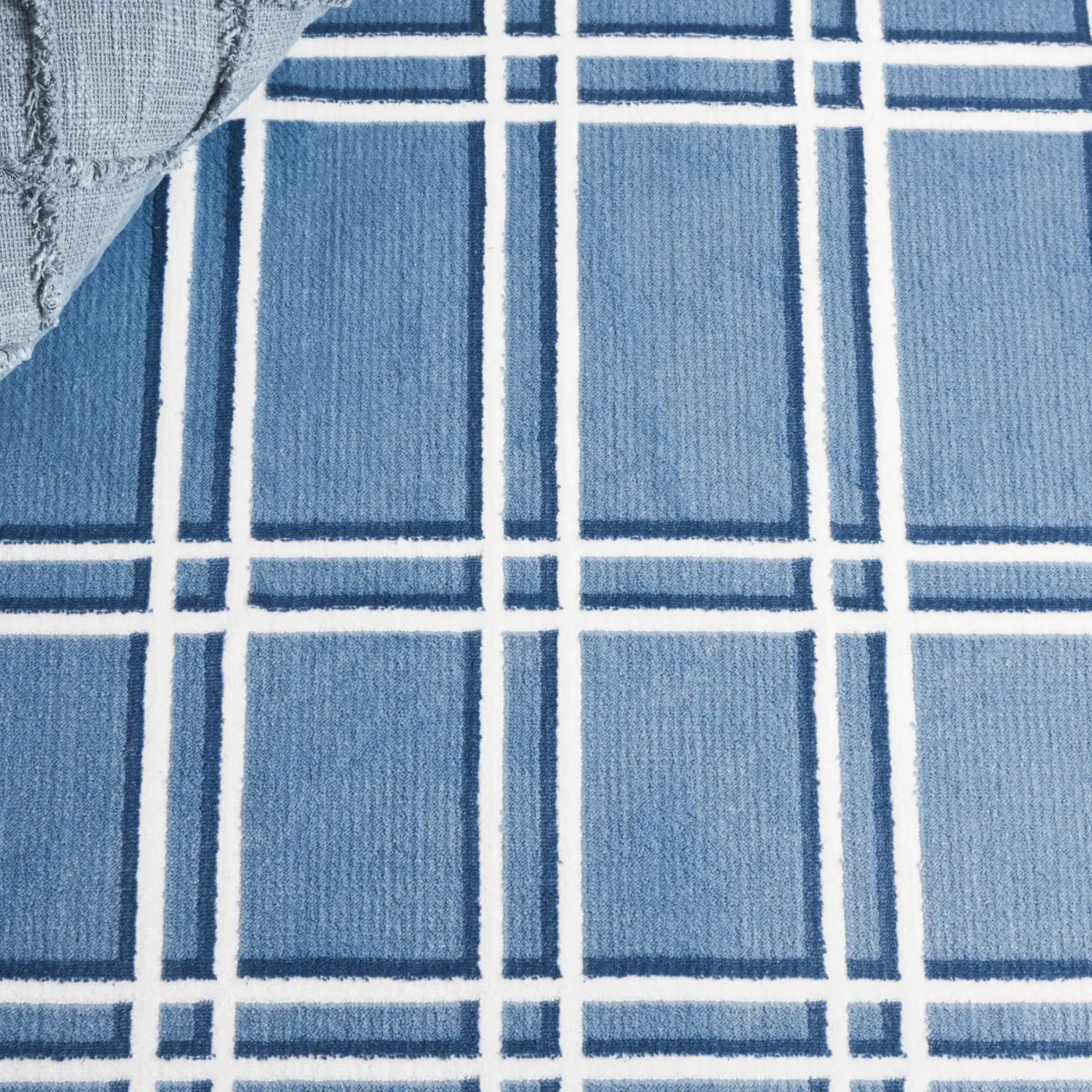 Groove Grid Rug in Blue / Ivory in a styled room