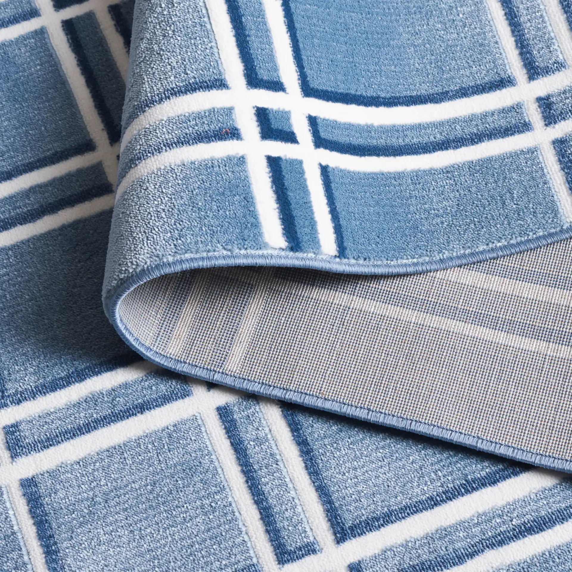 Groove Grid Rug in Blue / Ivory in a styled room