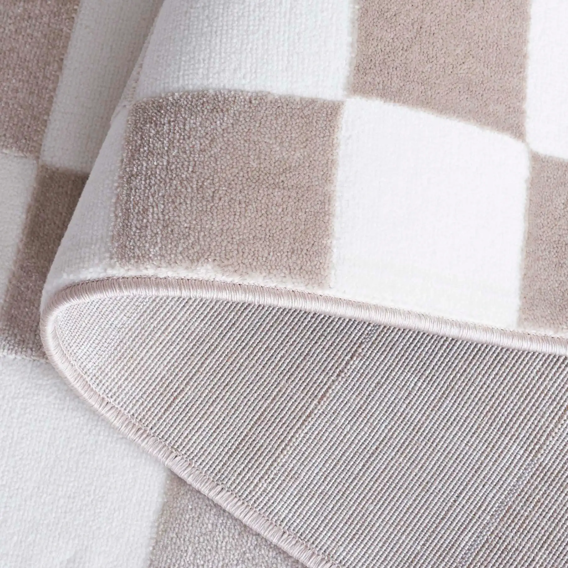 Groove Checkerboard Border Rug in Beige / Ivory in a styled room