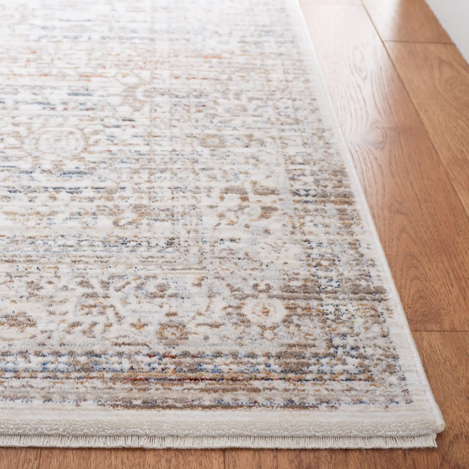 Harlow Faded Floral Bordered Rug in Ivory / Beige in a styled room
