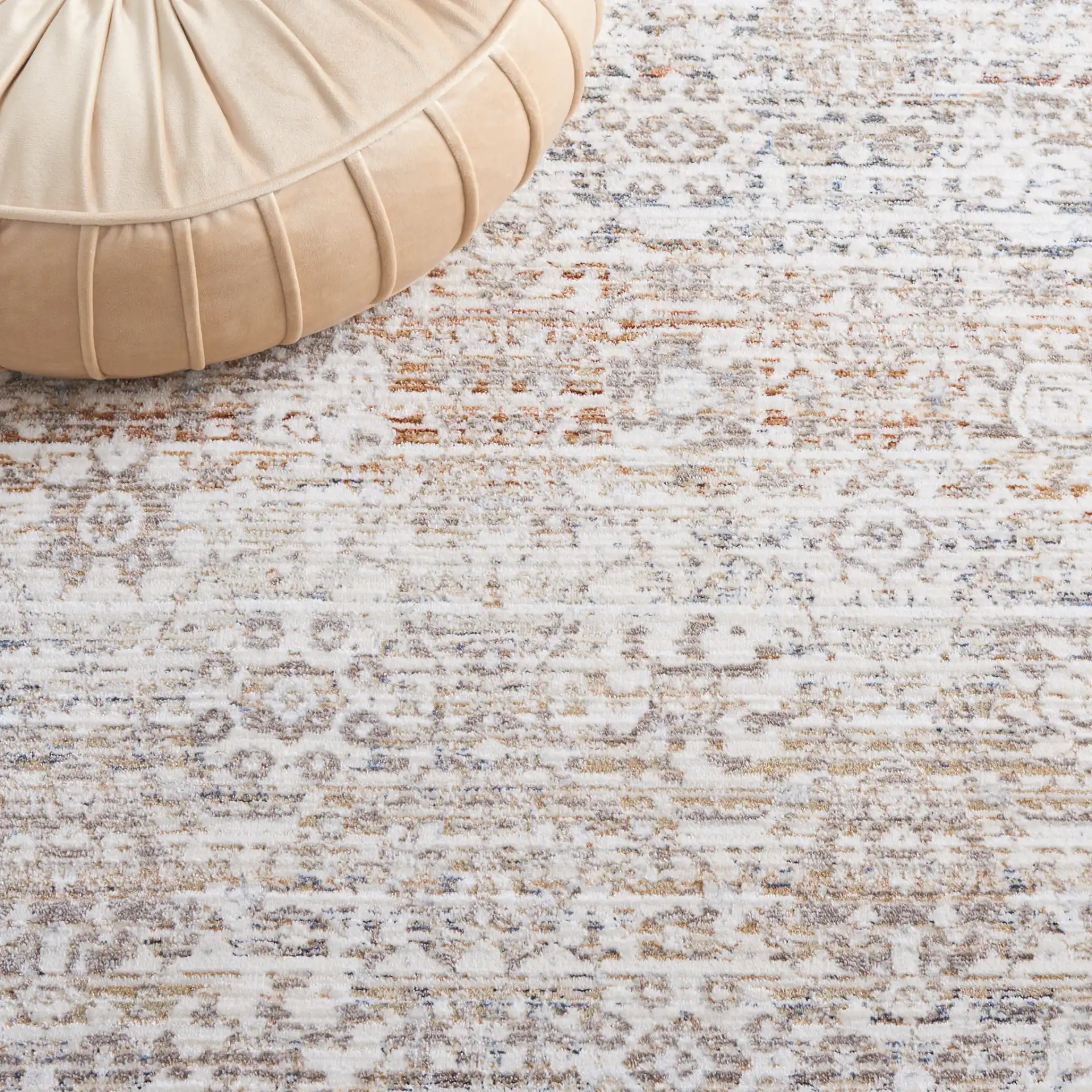 Harlow Faded Floral Bordered Rug in Ivory / Beige in a styled room