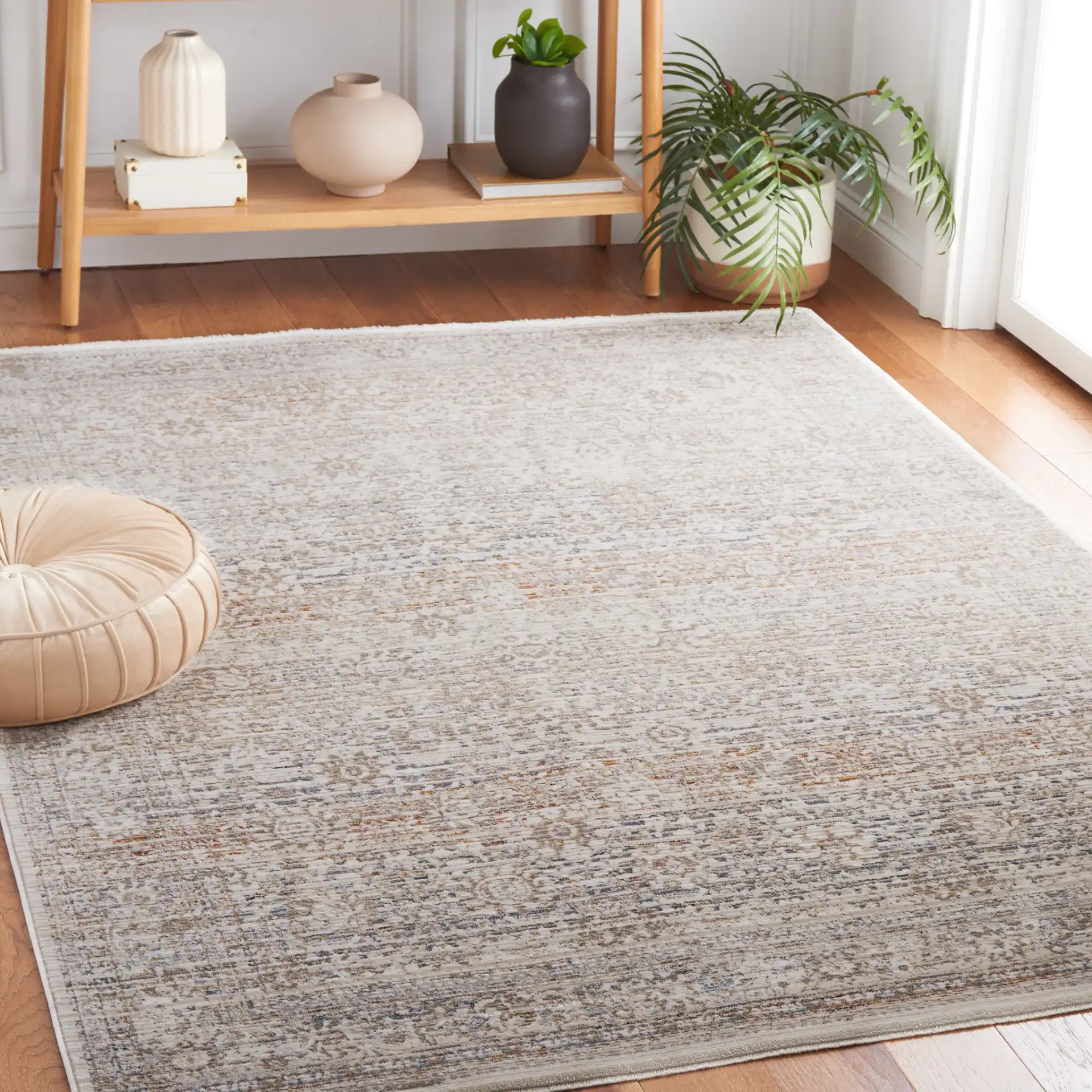 Harlow Faded Floral Bordered Rug in Ivory / Beige in a styled room