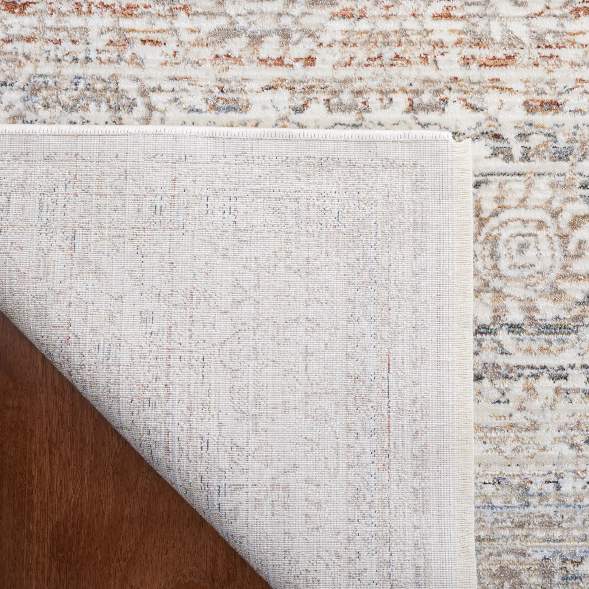 Harlow Faded Floral Bordered Rug in Ivory / Beige in a styled room