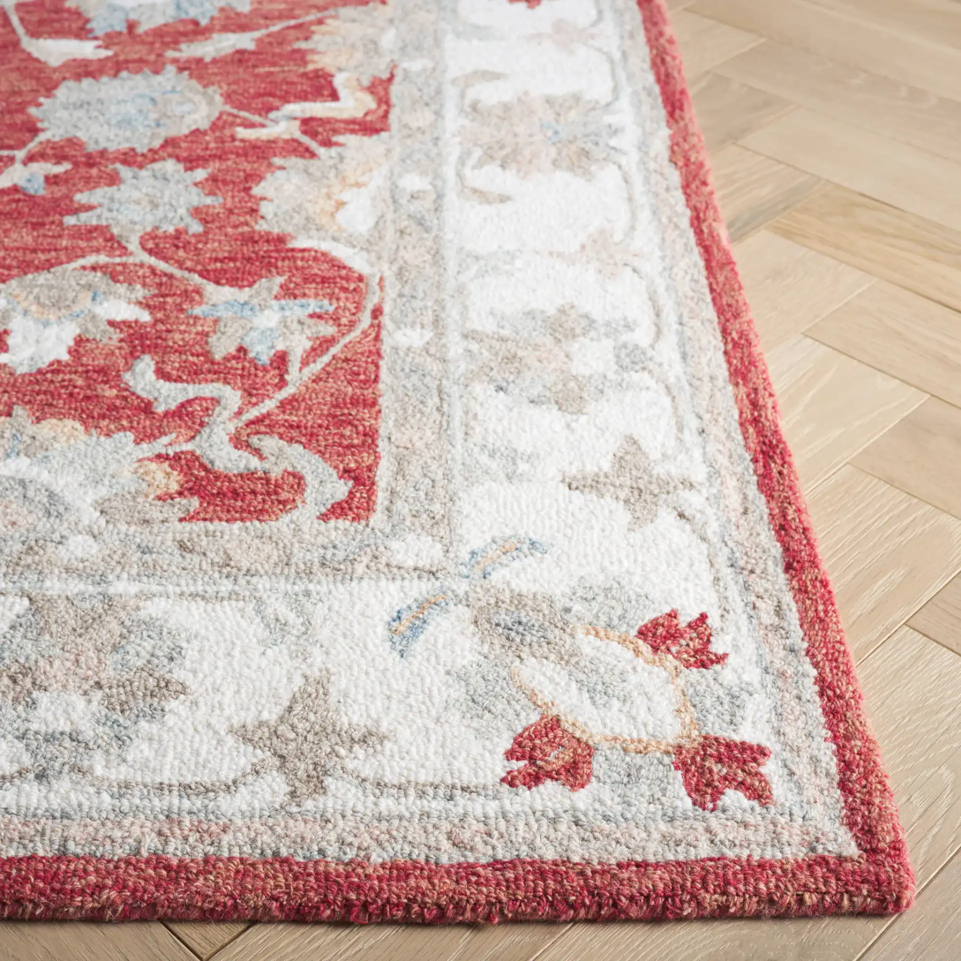 Heritage Bordered Floral Hand-Tufted Wool Rug in Red / Ivory in a styled room