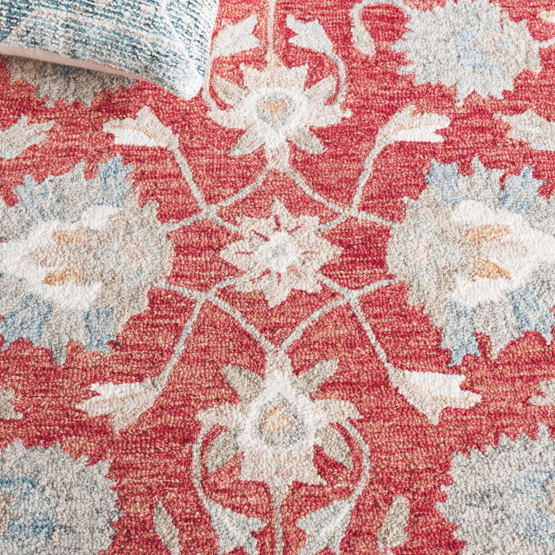 Heritage Bordered Floral Hand-Tufted Wool Rug in Red / Ivory in a styled room