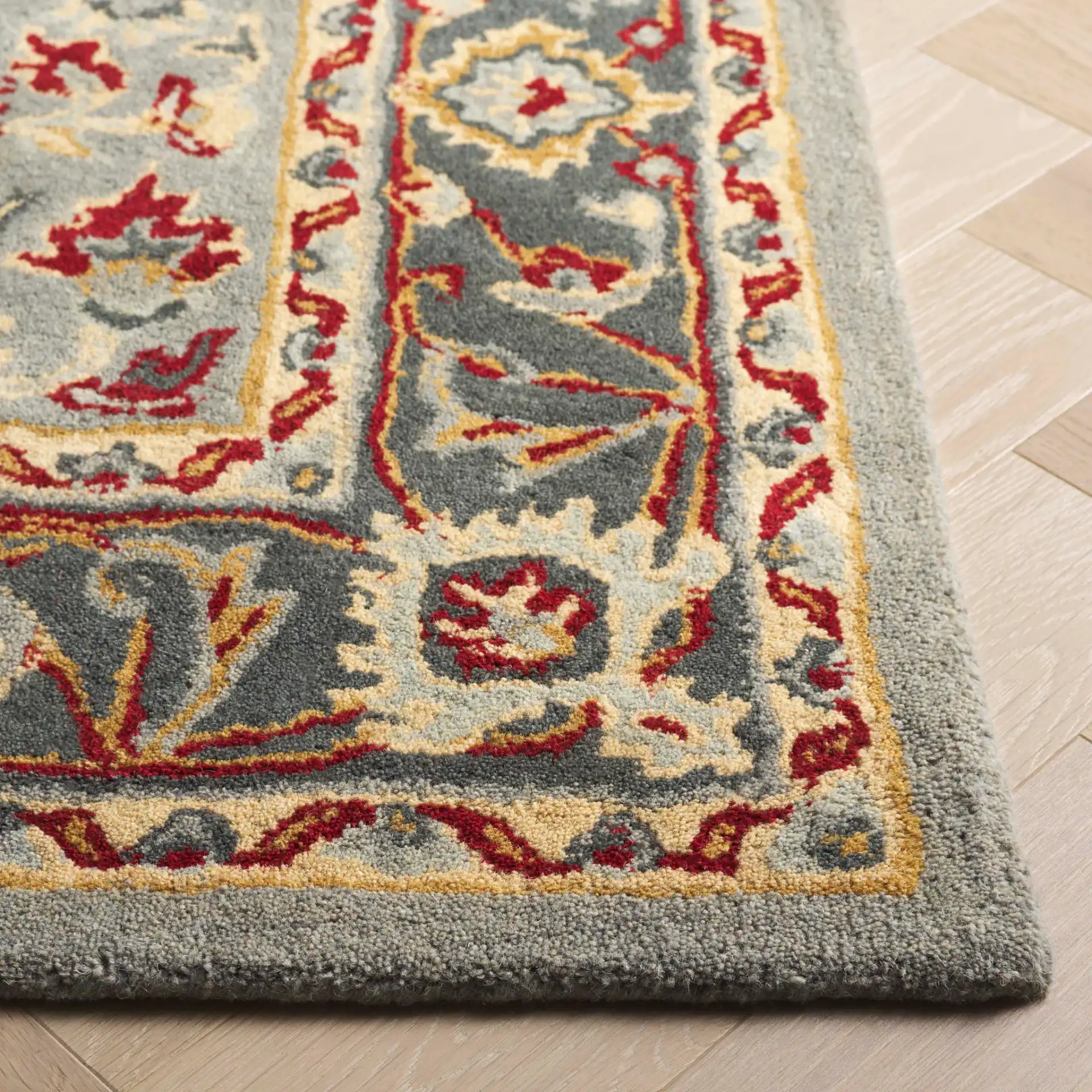 Heritage Palmette Medallion Hand-Tufted Wool Rug in Gray / Charcoal in a styled room