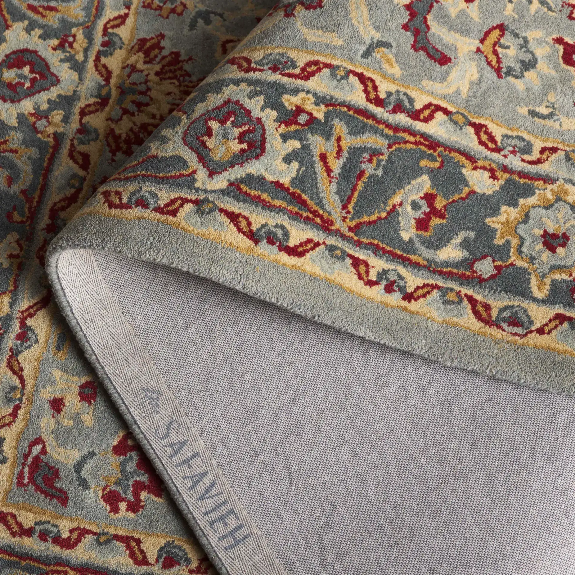 Heritage Palmette Medallion Hand-Tufted Wool Rug in Gray / Charcoal in a styled room