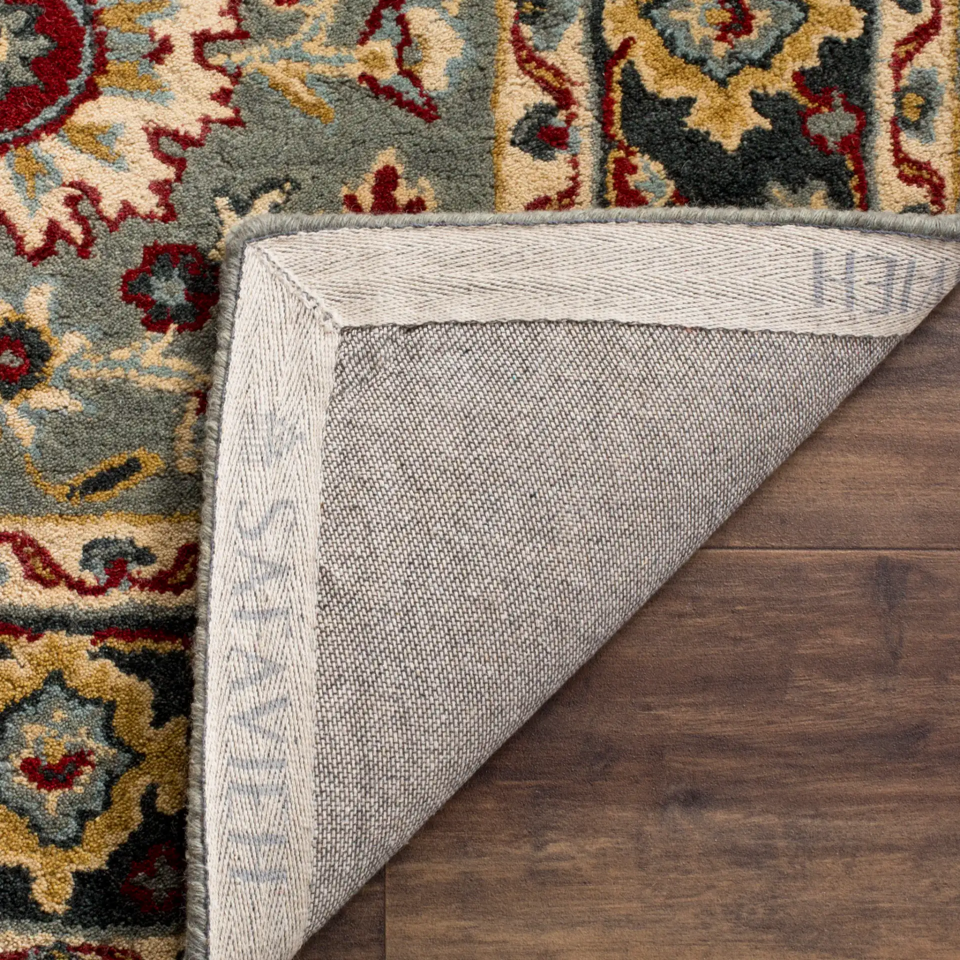 Heritage Palmette Medallion Hand-Tufted Wool Rug in Gray / Charcoal in a styled room