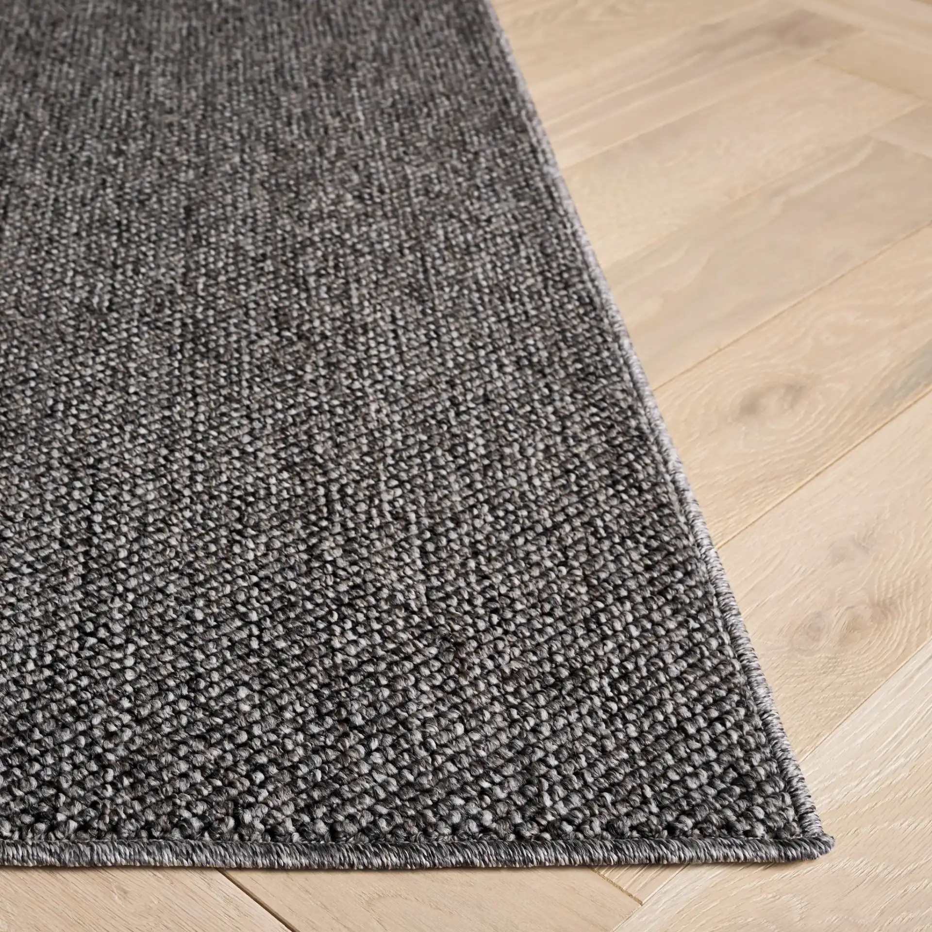 Highland Plain Modern Solid Rug in Charcoal / Gray in a styled room