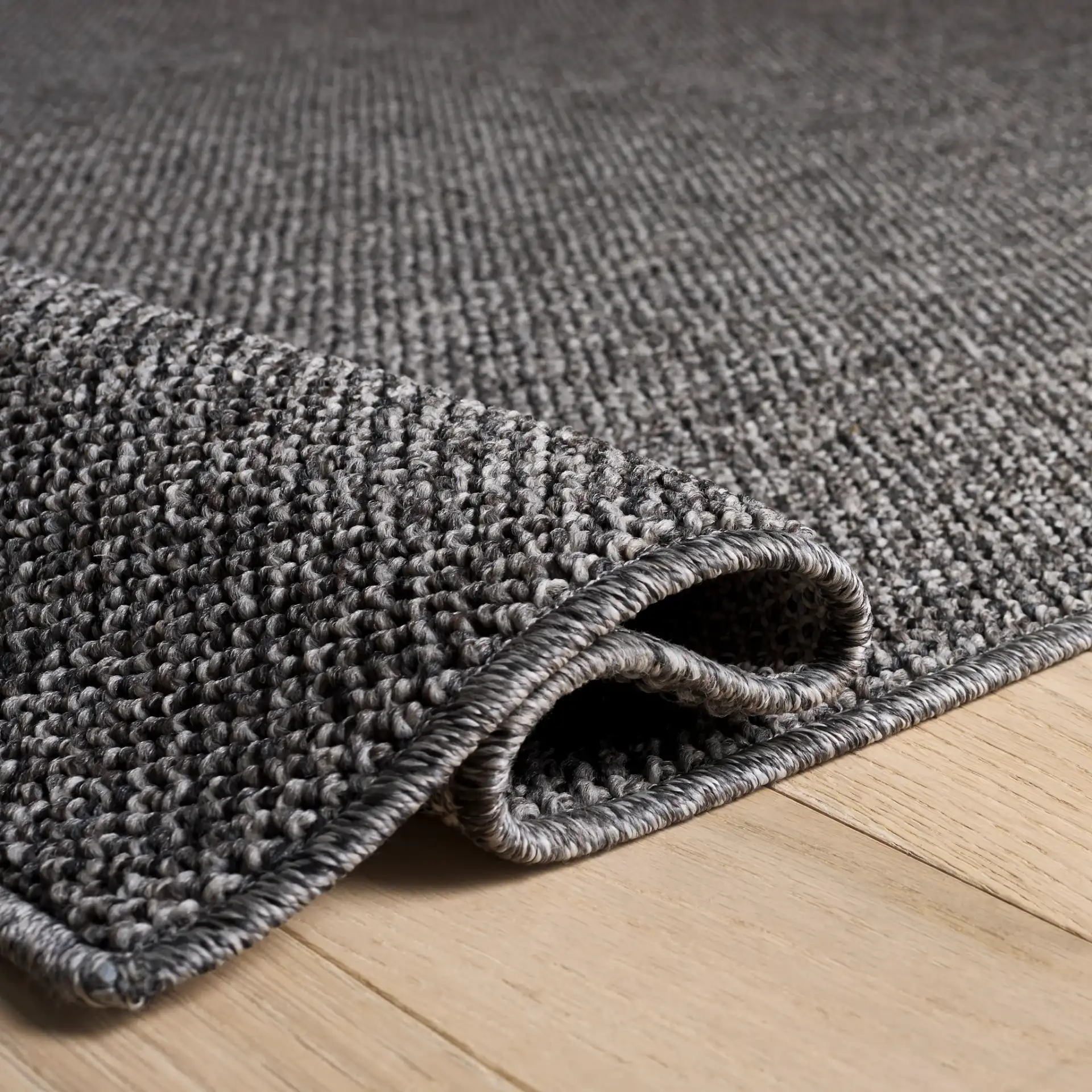 Highland Plain Modern Solid Rug in Charcoal / Gray in a styled room