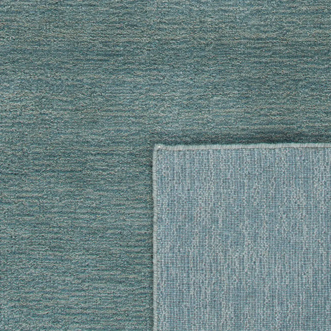 Himalaya Solid Hand-Loomed Wool Rug in Blue in a styled room