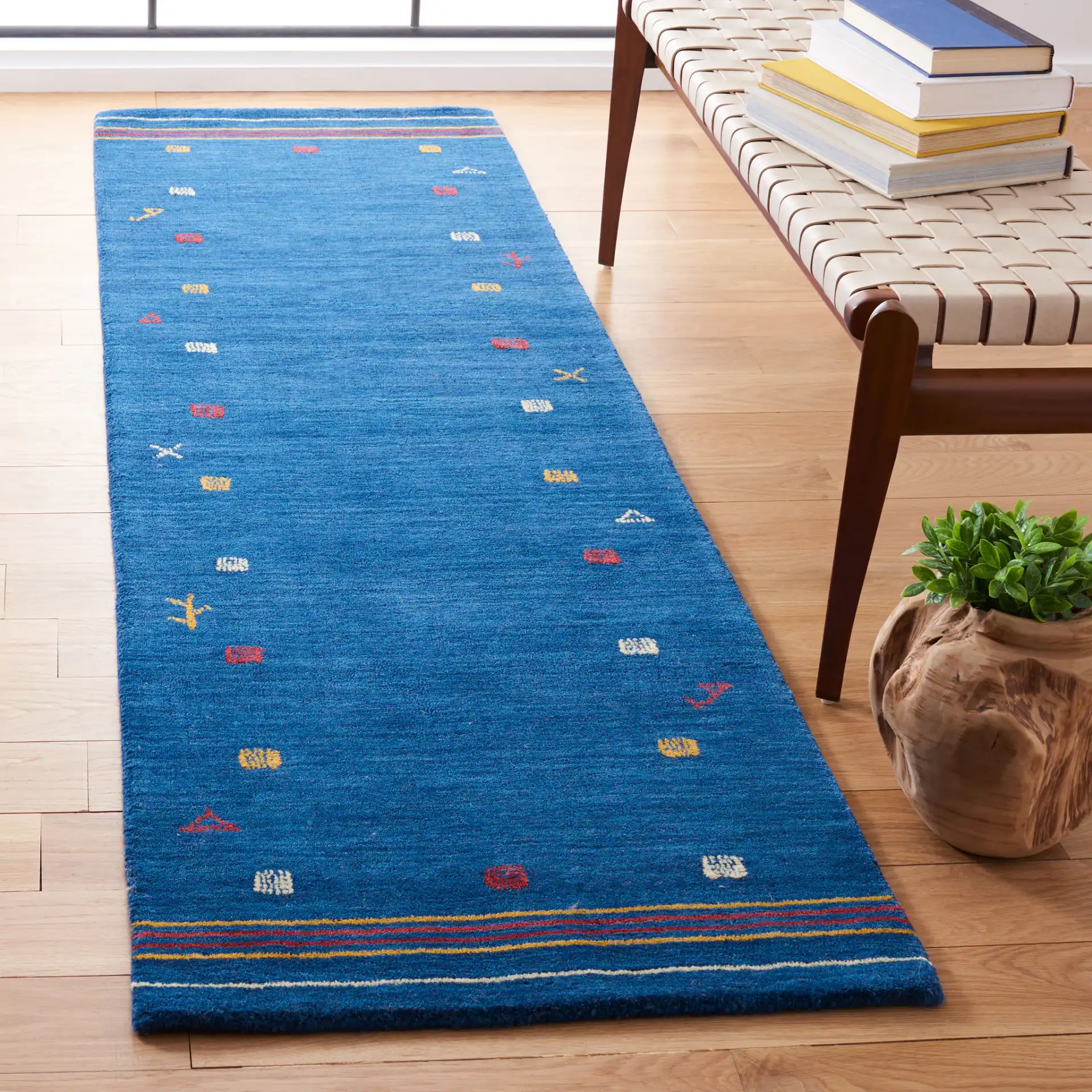 Himalaya Tribal Border Hand-Loomed Wool Rug in Blue in a styled room