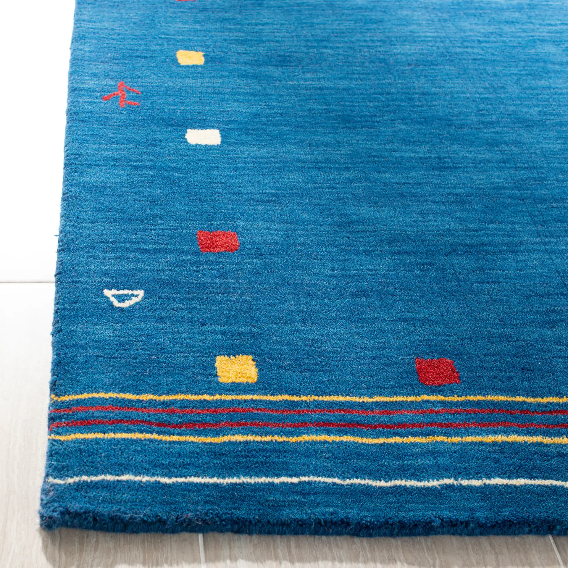Himalaya Tribal Border Hand-Loomed Wool Rug in Blue in a styled room
