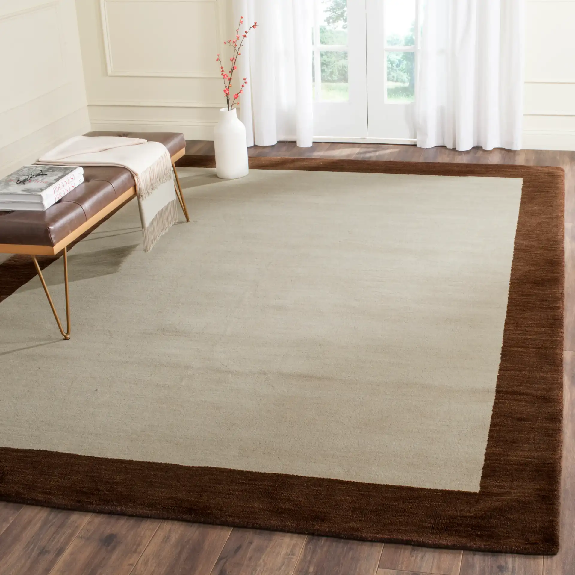 Himalaya Solid Bordered Hand-Loomed Wool Rug in Beige / Dark Brown in a styled room