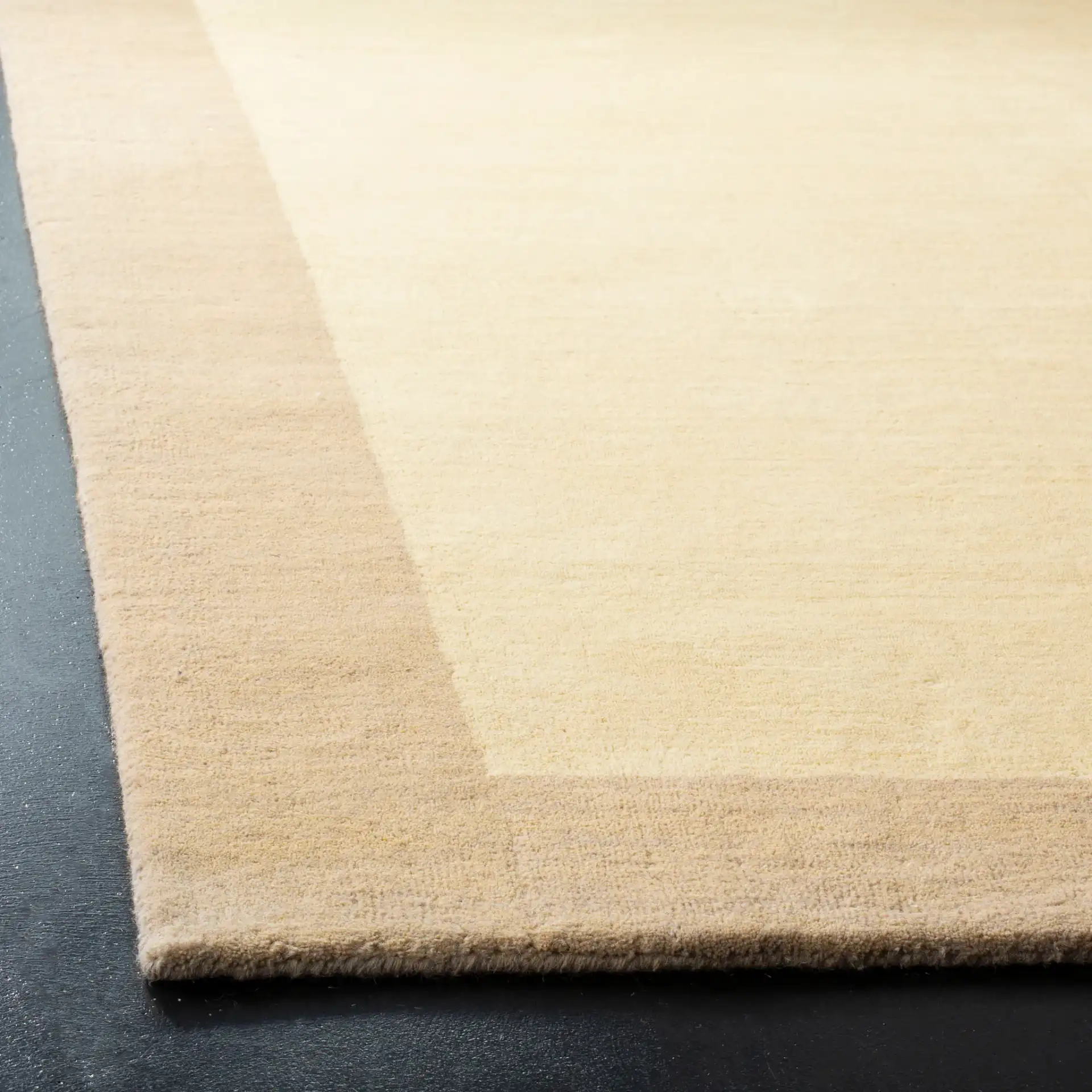 Himalaya Solid Bordered Hand-Loomed Wool Rug in Ivory / Beige in a styled room