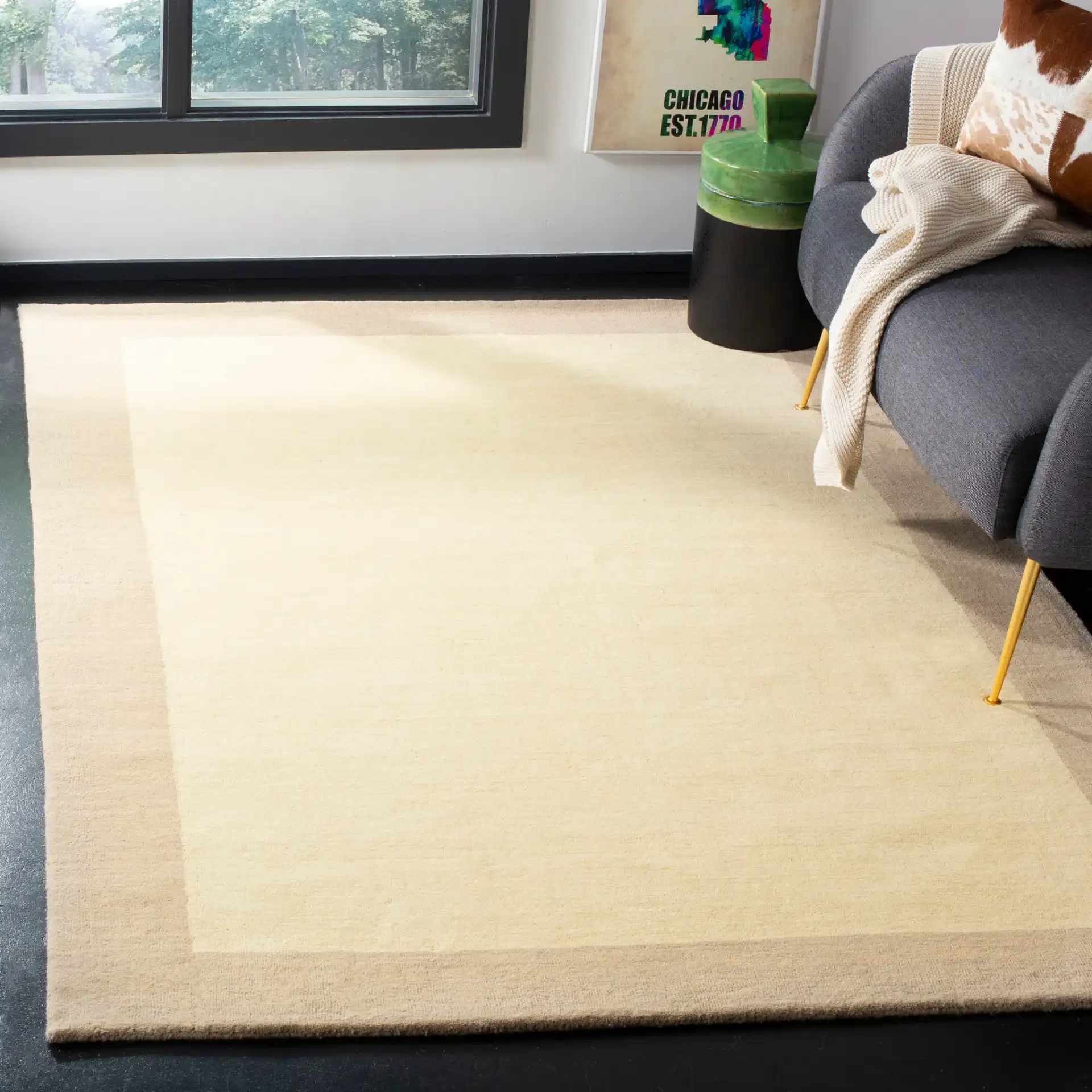 Himalaya Solid Bordered Hand-Loomed Wool Rug in Ivory / Beige in a styled room