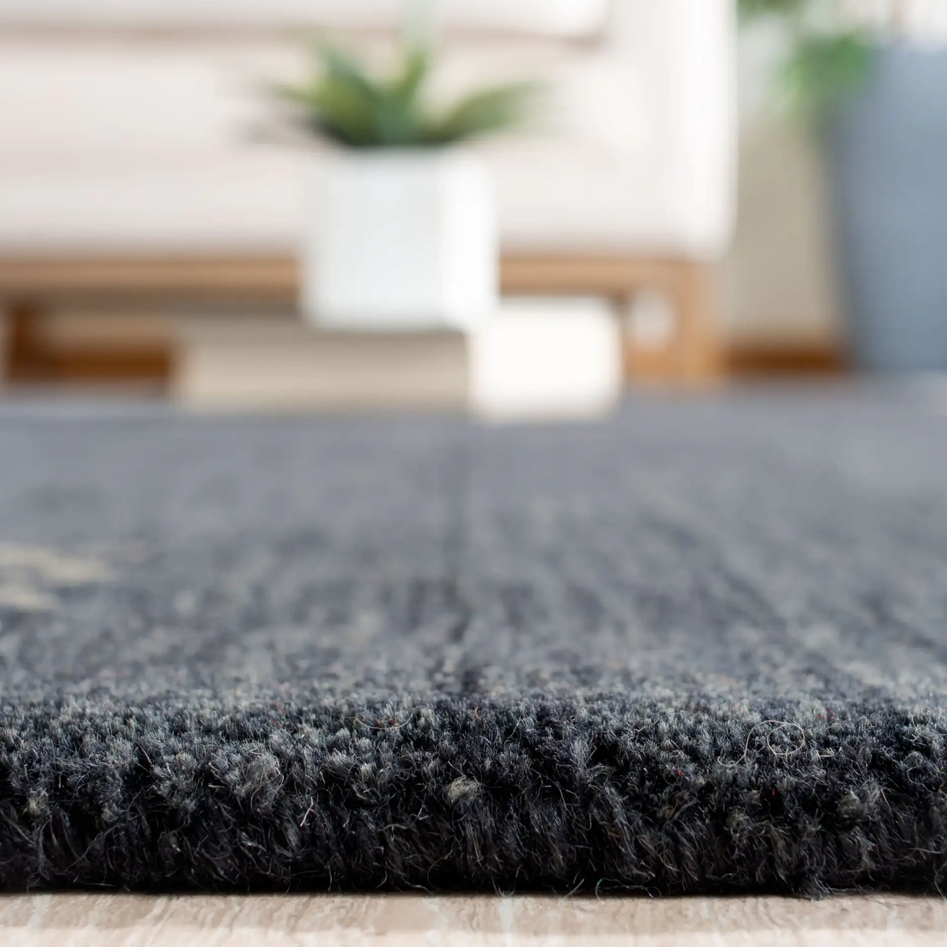 Himalaya Bordered Hand-Loomed Wool Rug in Charcoal in a styled room