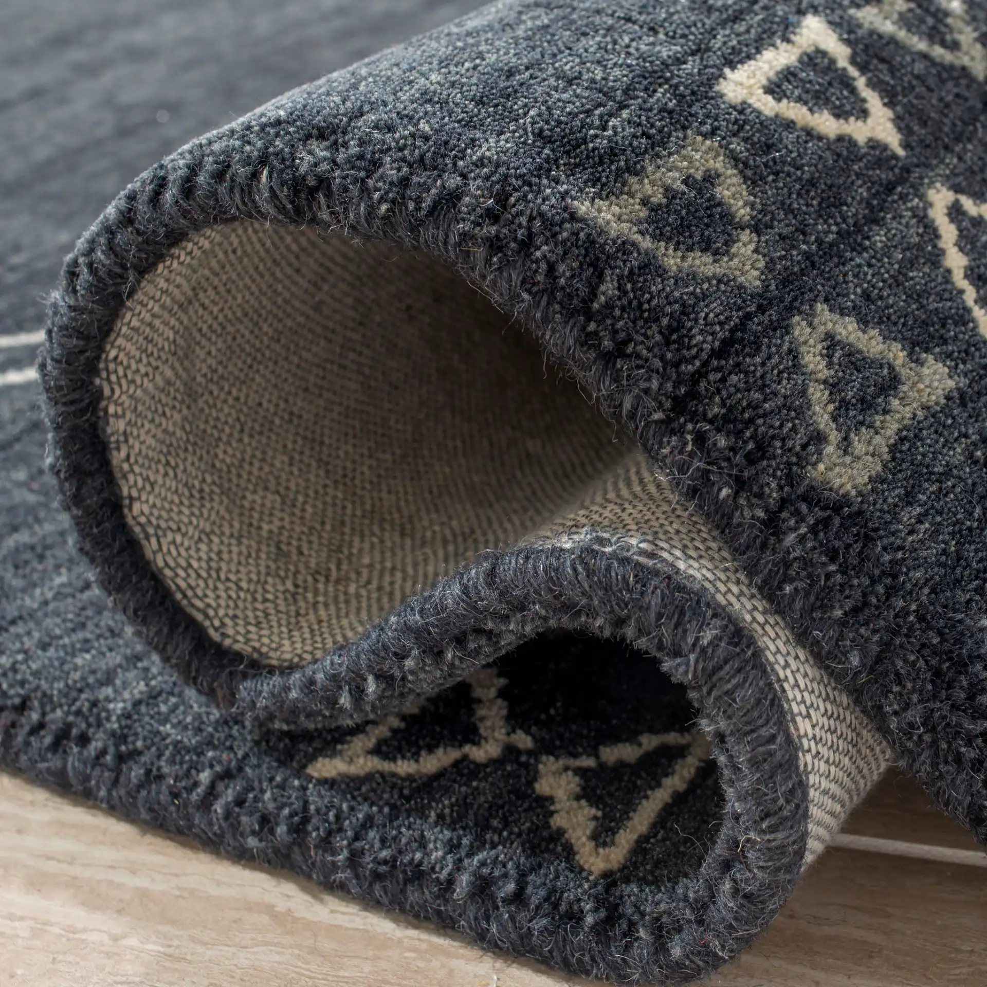 Himalaya Bordered Hand-Loomed Wool Rug in Charcoal in a styled room