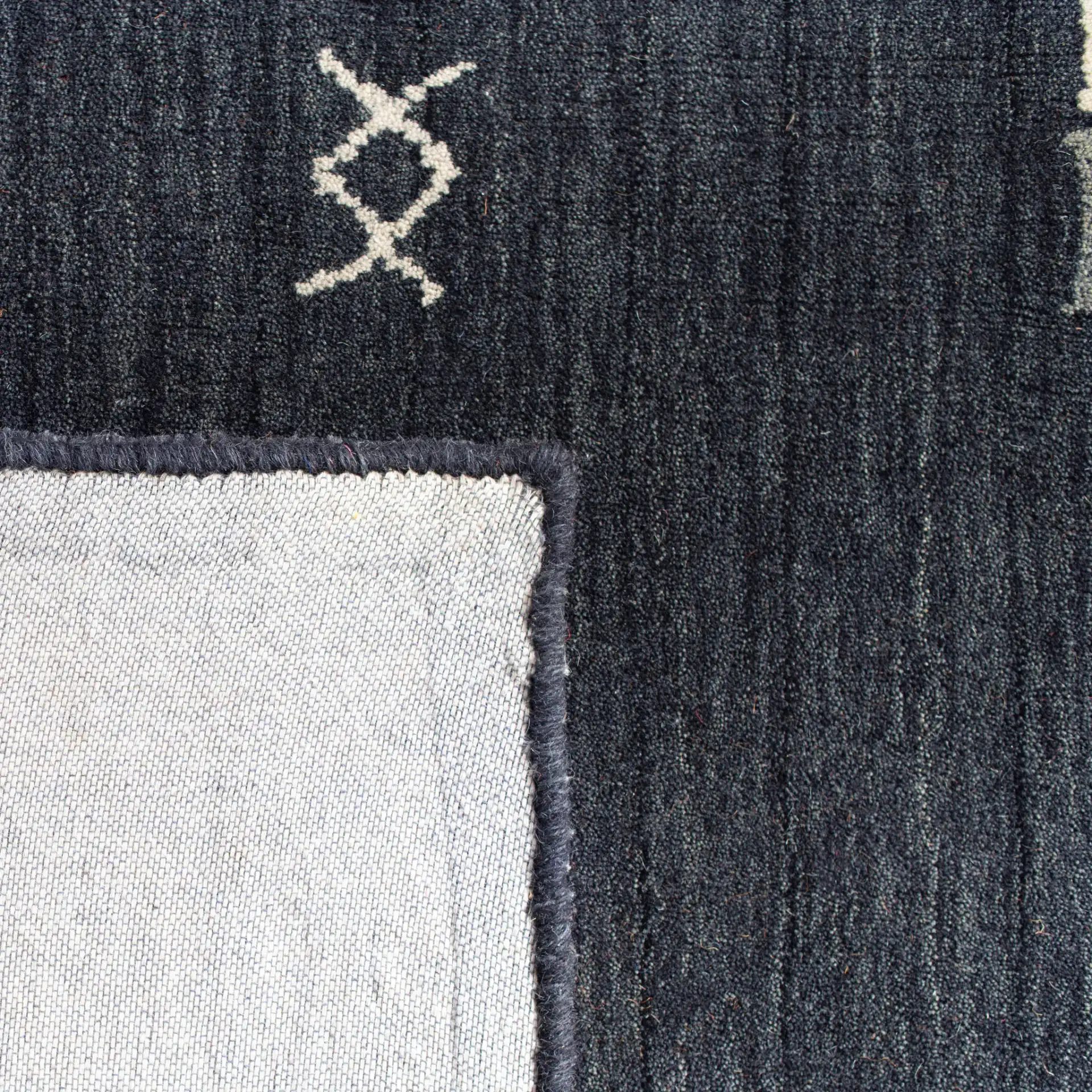 Himalaya Bordered Hand-Loomed Wool Rug in Charcoal in a styled room