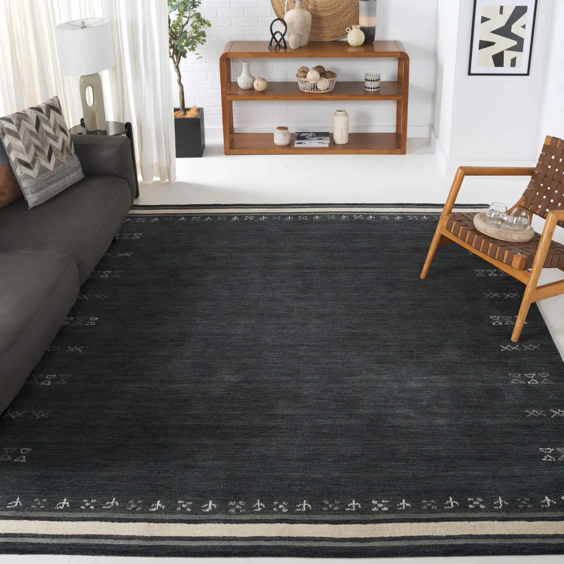 Himalaya Bordered Hand-Loomed Wool Rug in Charcoal in a styled room