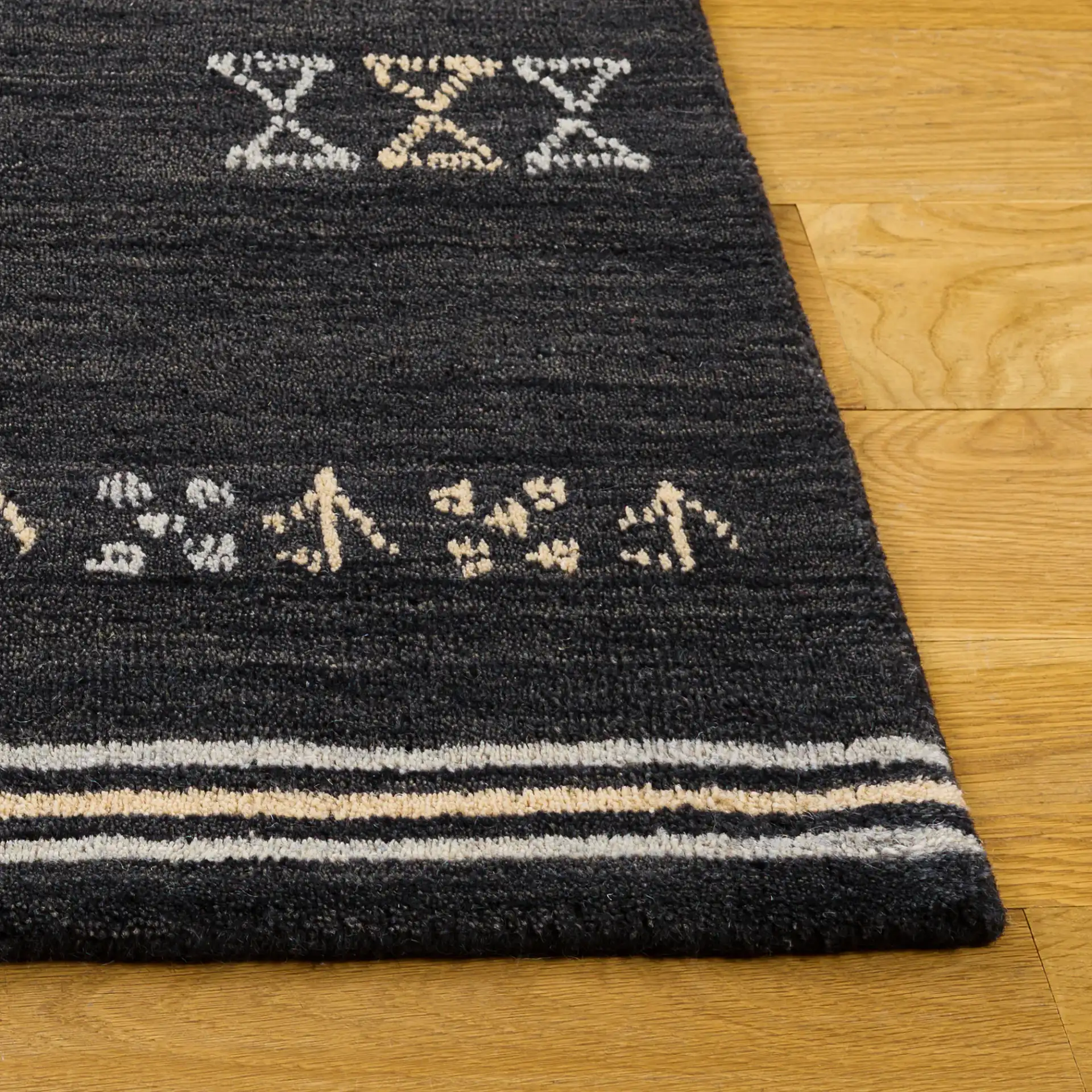Himalaya Bordered Hand-Loomed Wool Rug in Charcoal in a styled room
