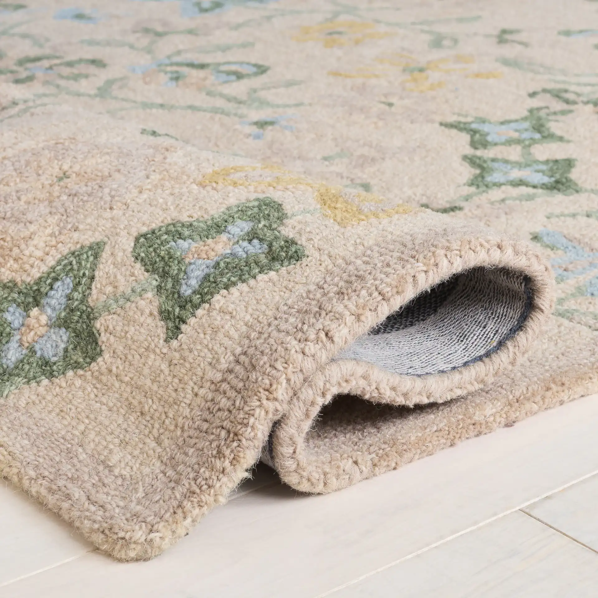 Chelsea Floral Vine Hand-Tufted Wool Rug in Beige / Green in a styled room