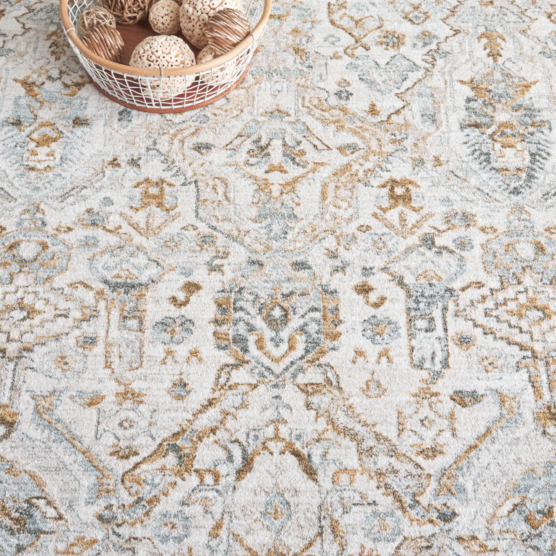 Hamilton Distressed Floral Bordered Rug in Gray / Blue in a styled room