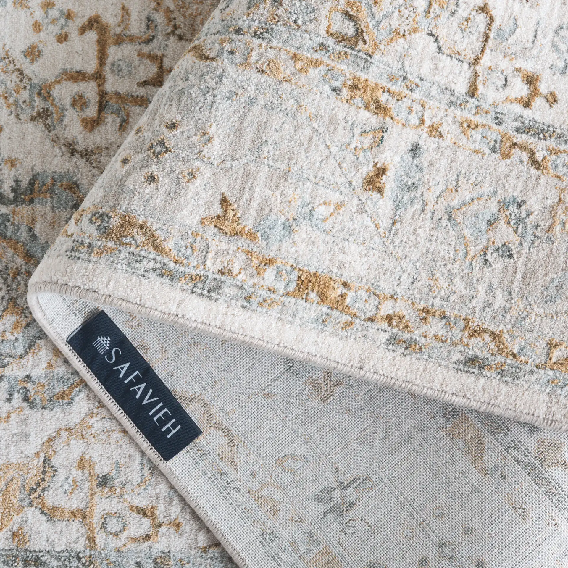 Hamilton Distressed Floral Bordered Rug in Gray / Blue in a styled room