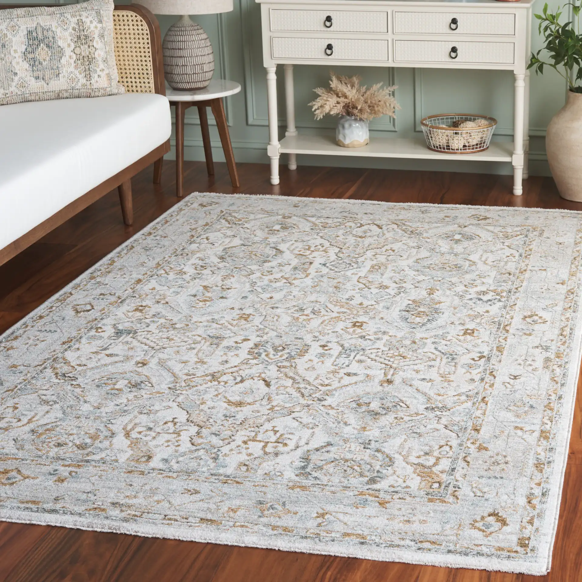 Hamilton Distressed Floral Bordered Rug in Gray / Blue in a styled room