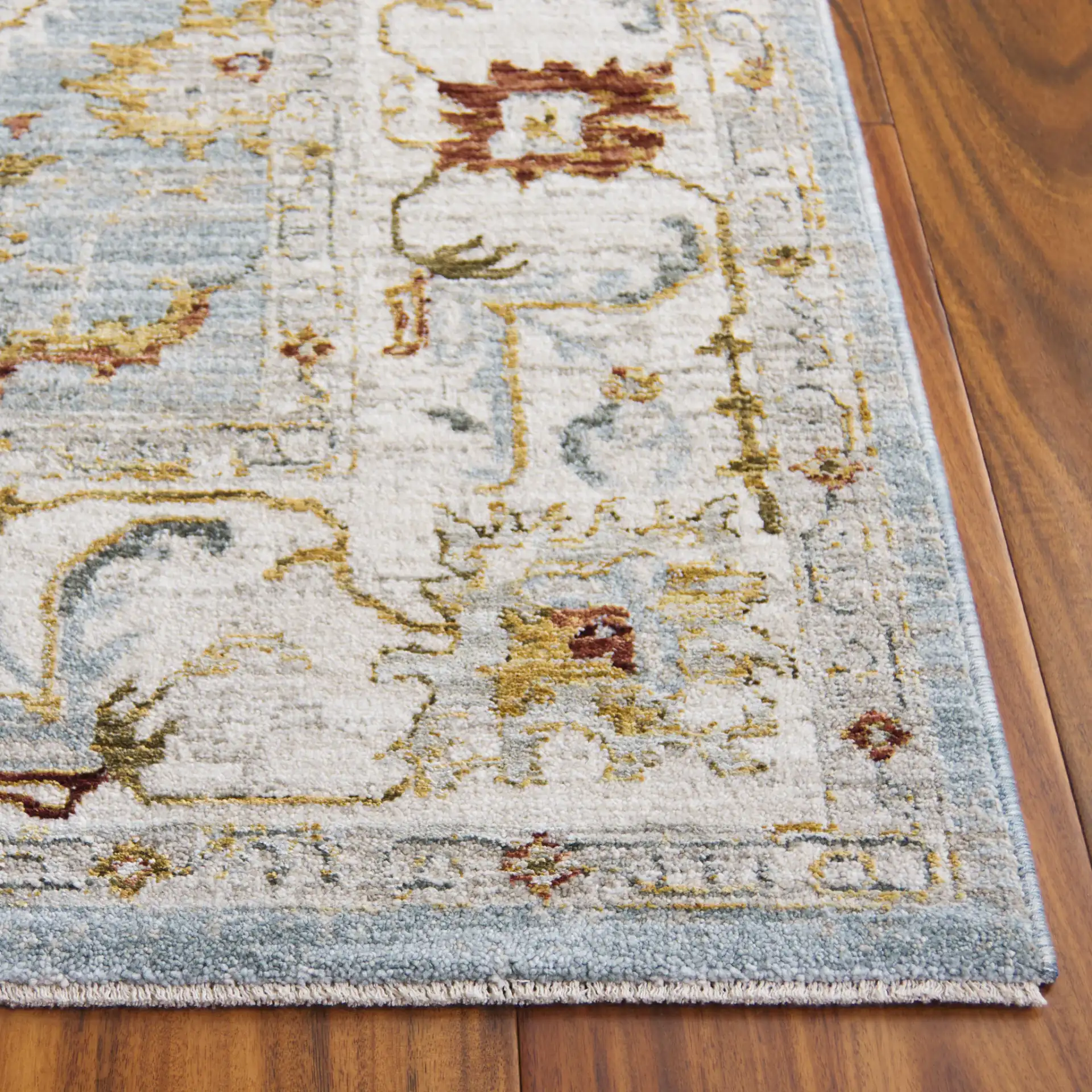 Hamilton Floral Bordered Rug in Blue / Gold in a styled room