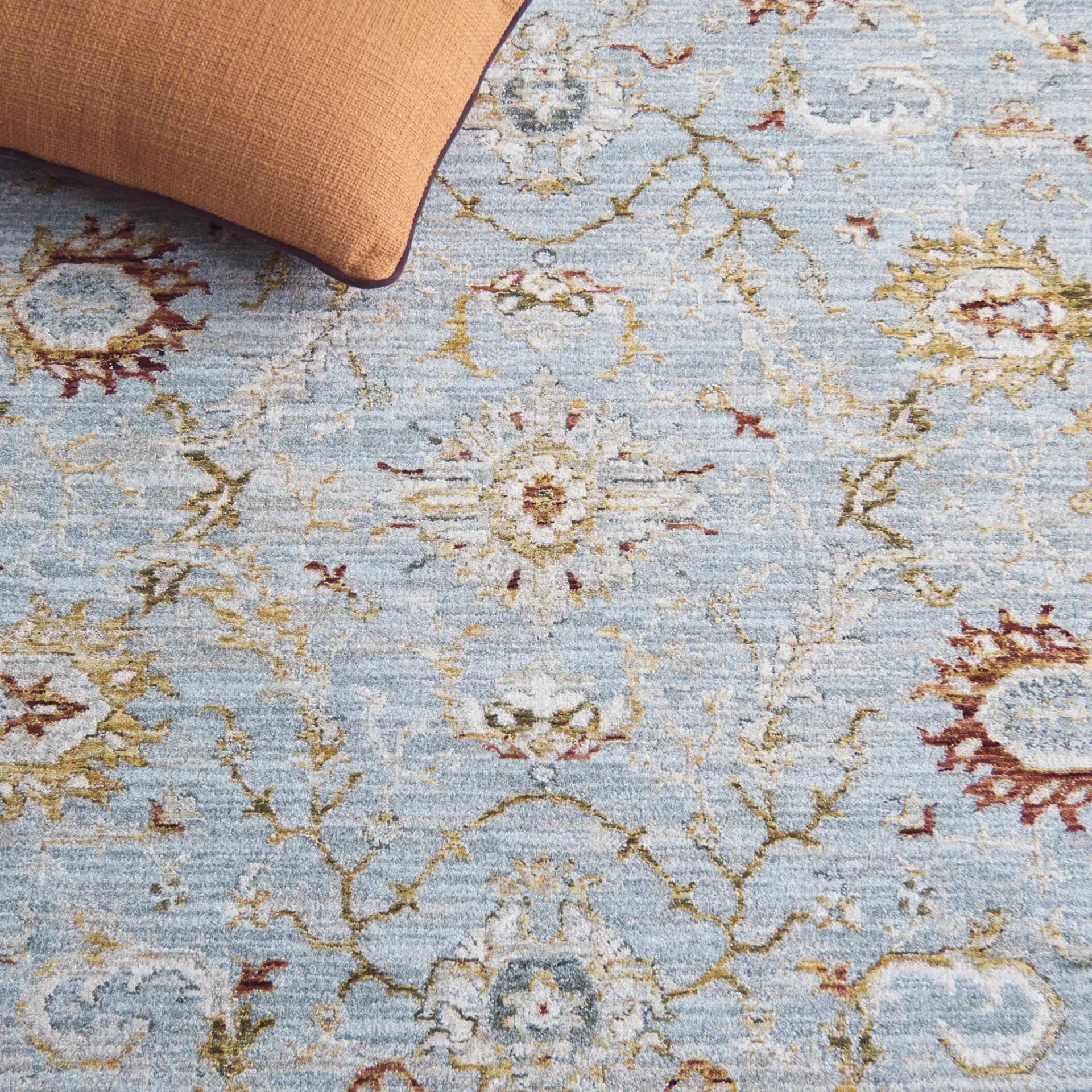 Hamilton Floral Bordered Rug in Blue / Gold in a styled room