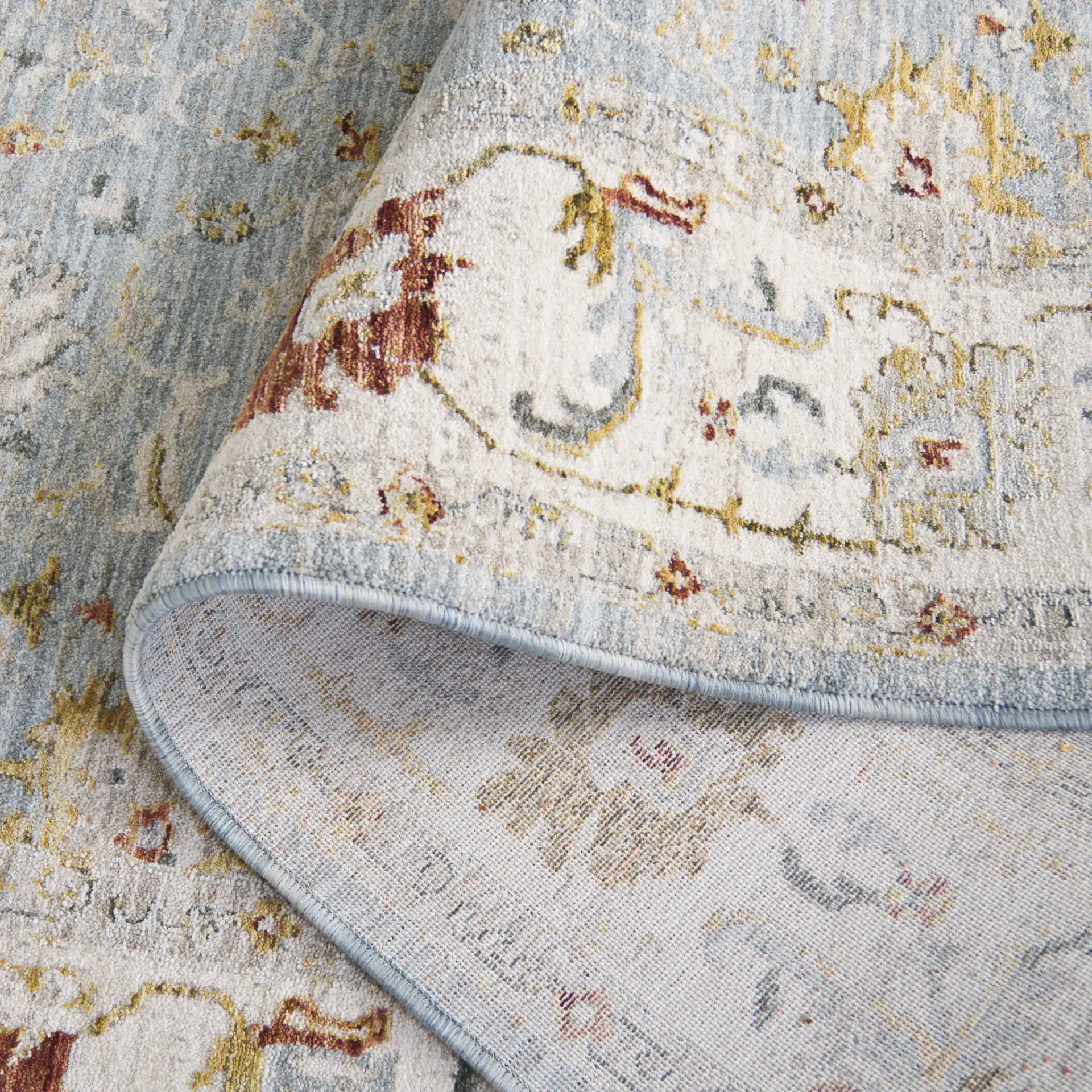 Hamilton Floral Bordered Rug in Blue / Gold in a styled room