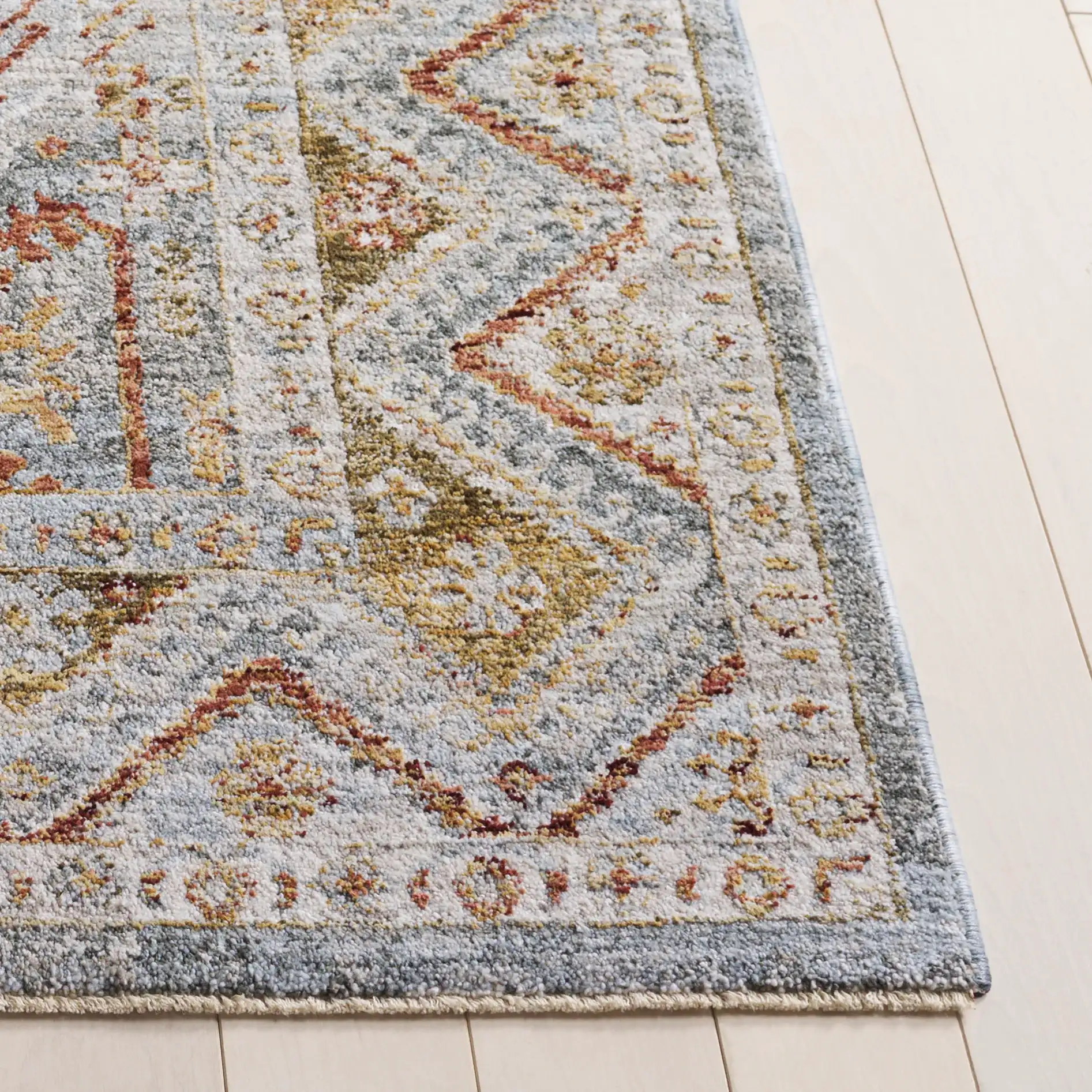 Hamilton Tribal Border Rug in Blue / Gold Rust in a styled room