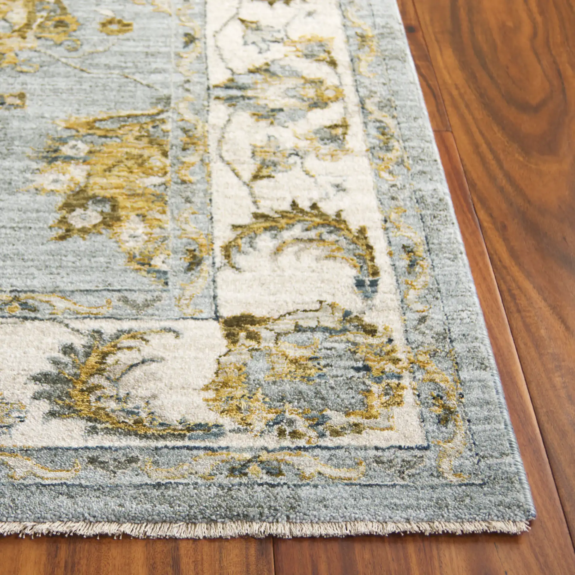 Hamilton Bordered Floral Rug in Blue / Gold in a styled room