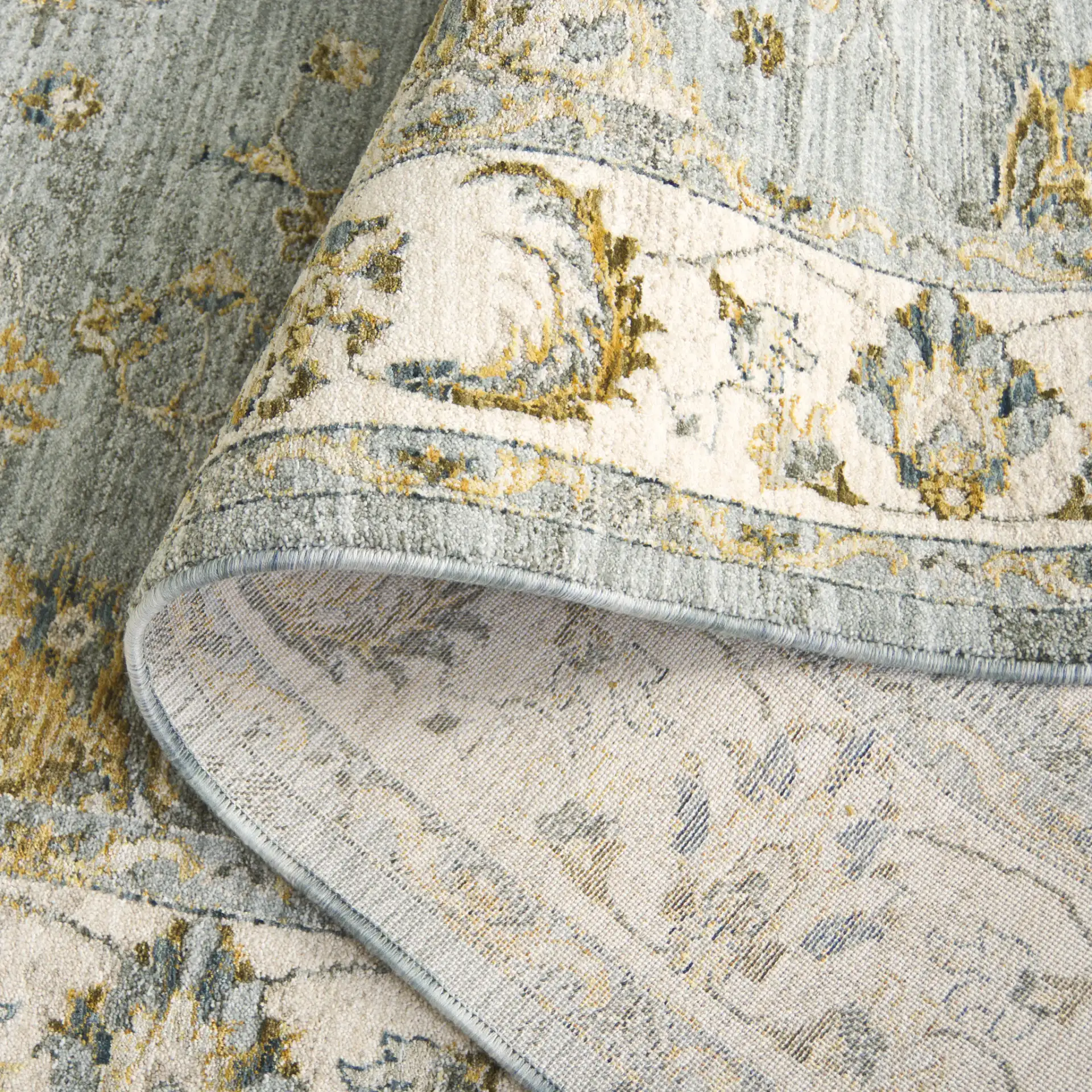 Hamilton Bordered Floral Rug in Blue / Gold in a styled room